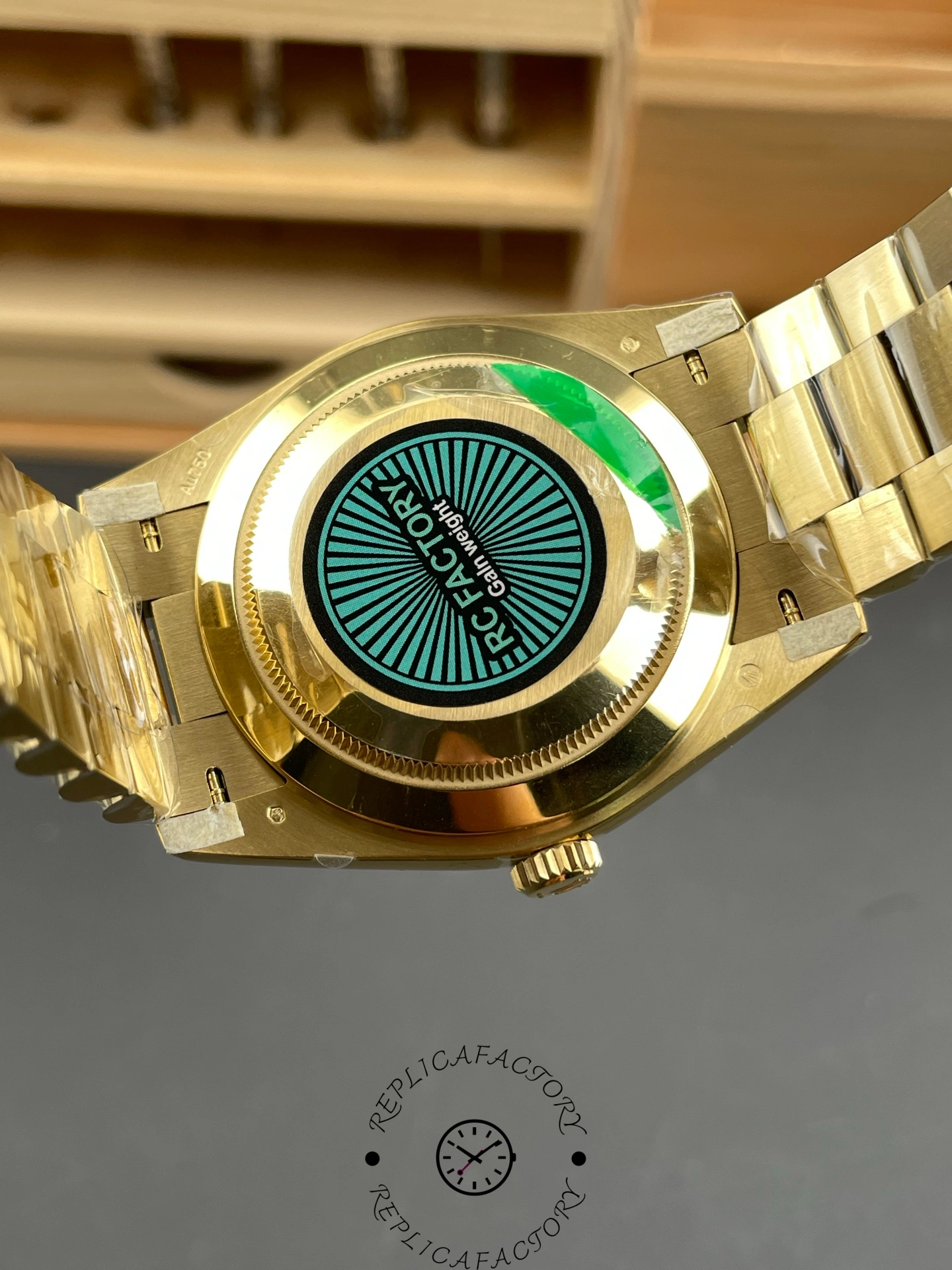 Caseback view of the Rolex Day-Date 228238 with RC Factory label and gold finish.