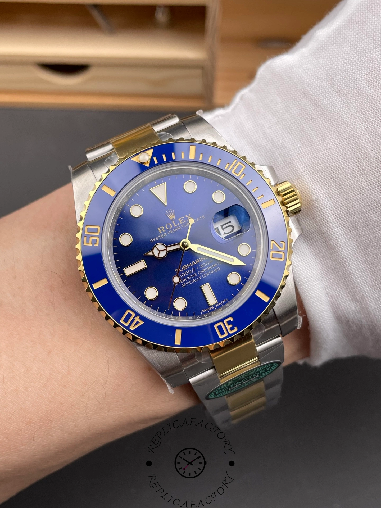 Wrist shot of the Rolex Submariner 116613LB two-tone blue dial watch showing its elegant fit.