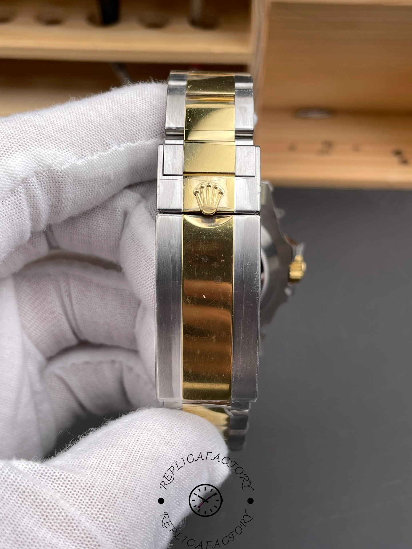Close-up of the two-tone bracelet clasp with Rolex crown logo.