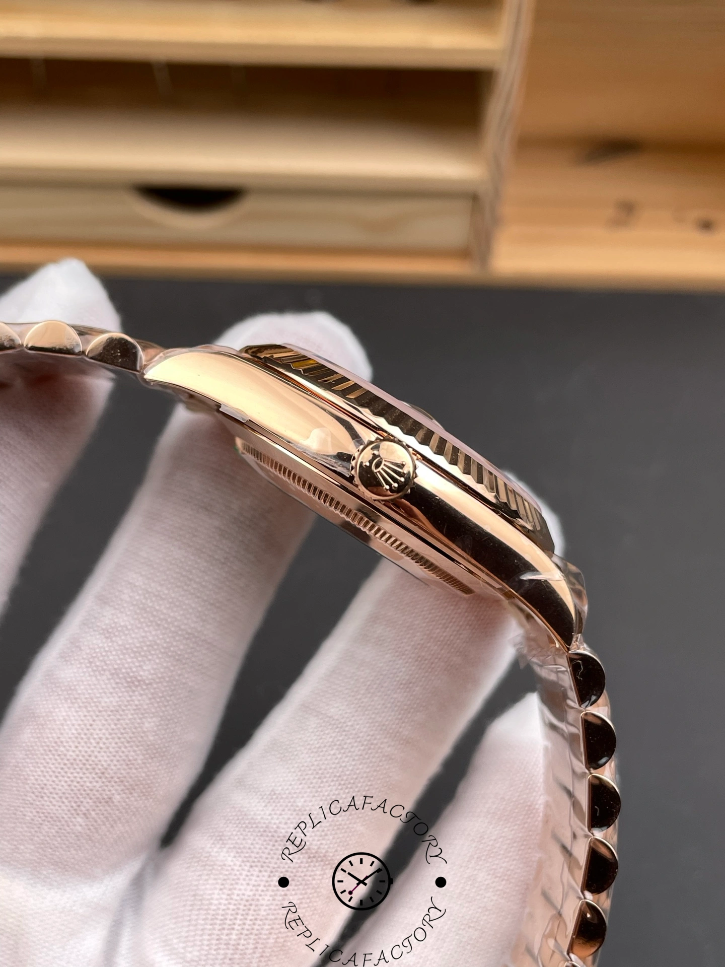 Alternate side angle highlighting the fluted bezel and crown with Rolex logo on the Day-Date 40.