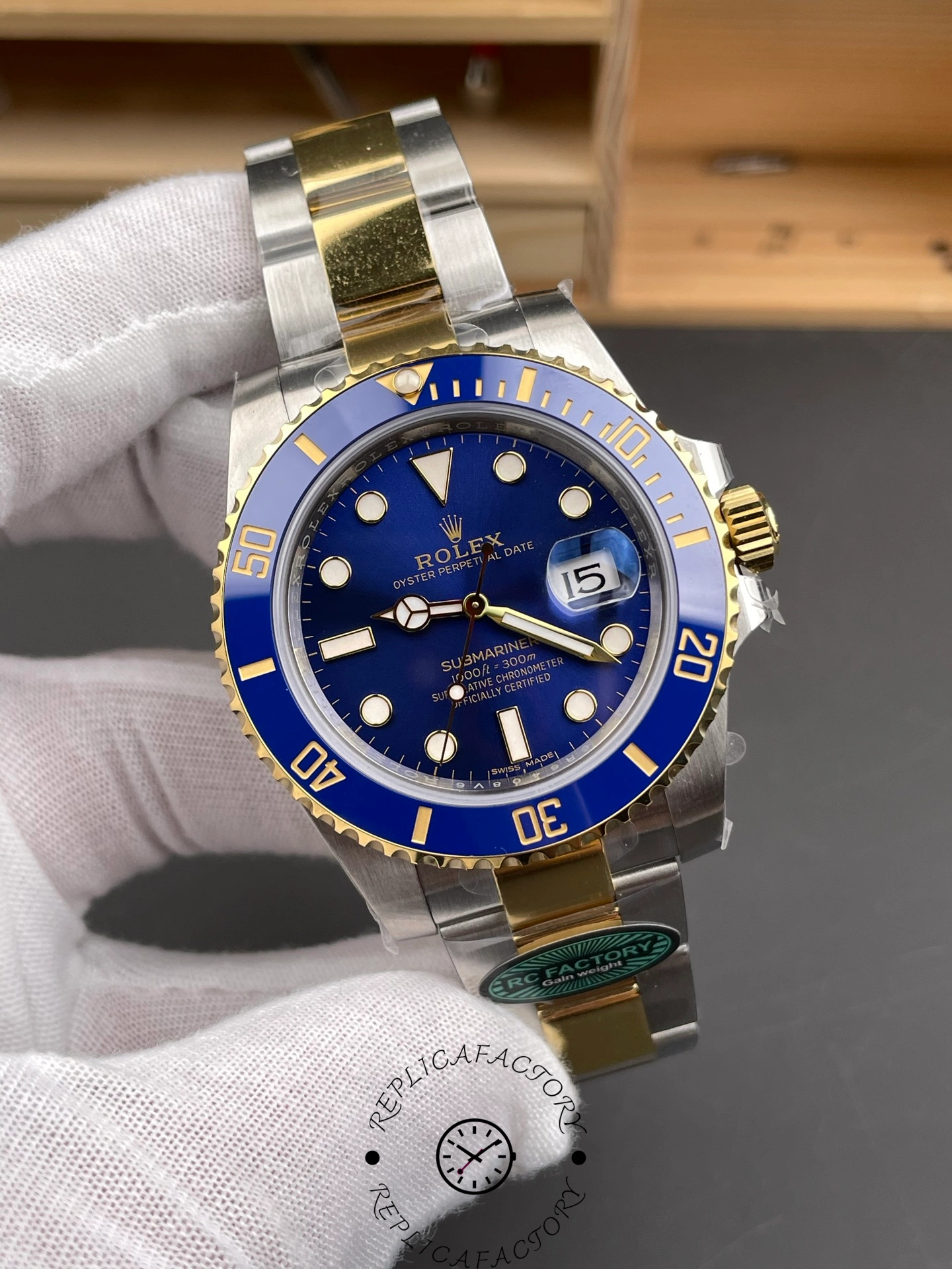 Angled front view of the Rolex Submariner 116613LB showing the blue dial, gold accents, and date display.