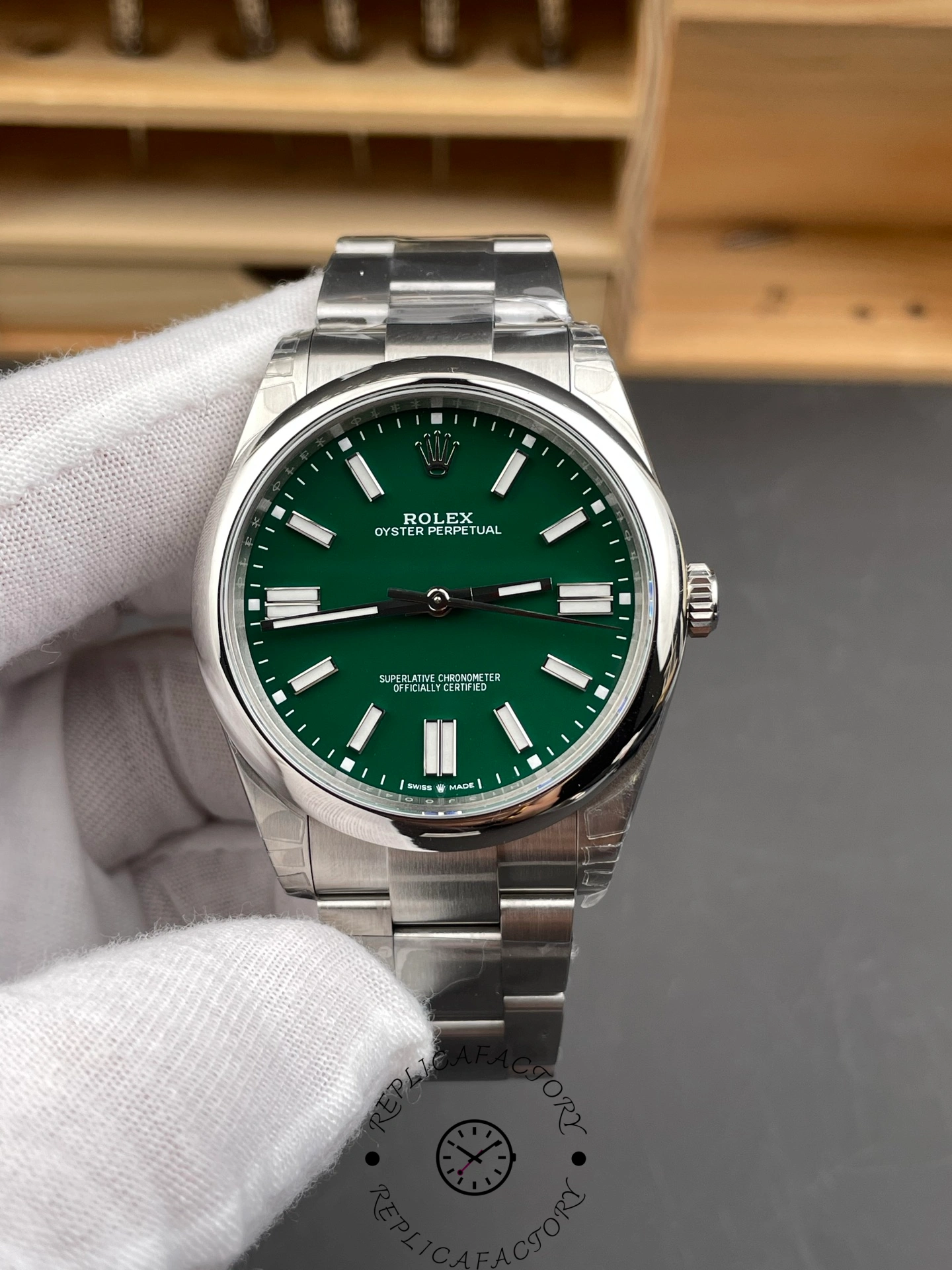 Close-up front view of the Rolex Oyster Perpetual 41 with green dial and polished stainless steel case.