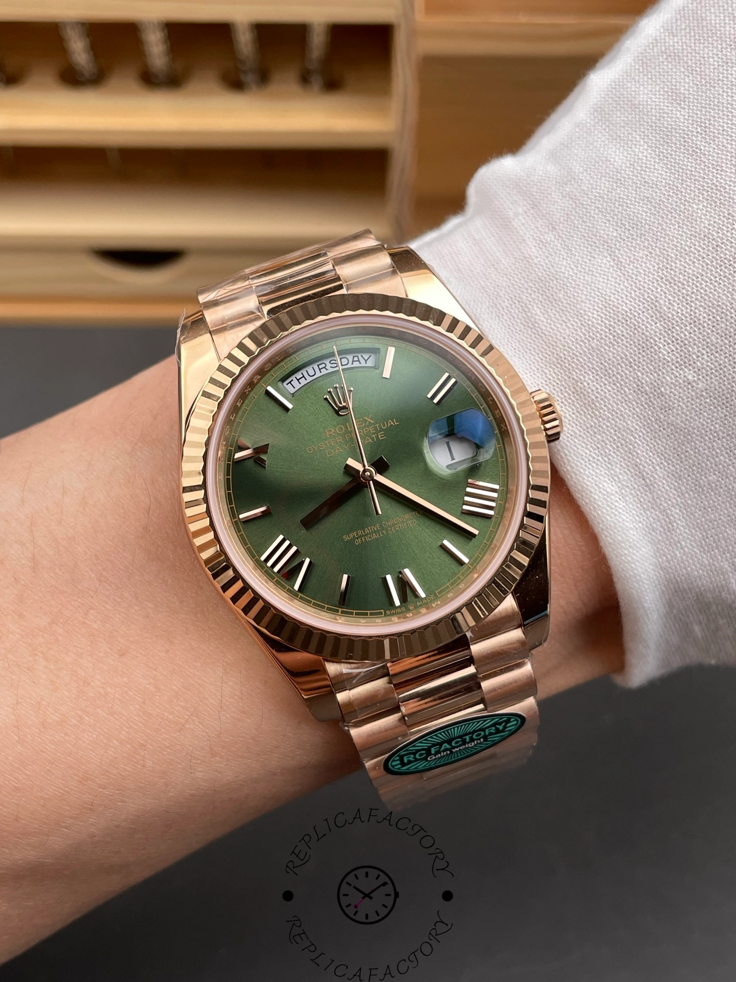 Wrist shot of the Rolex Day-Date 40 Everose gold with olive-green dial showing on-wrist appearance.