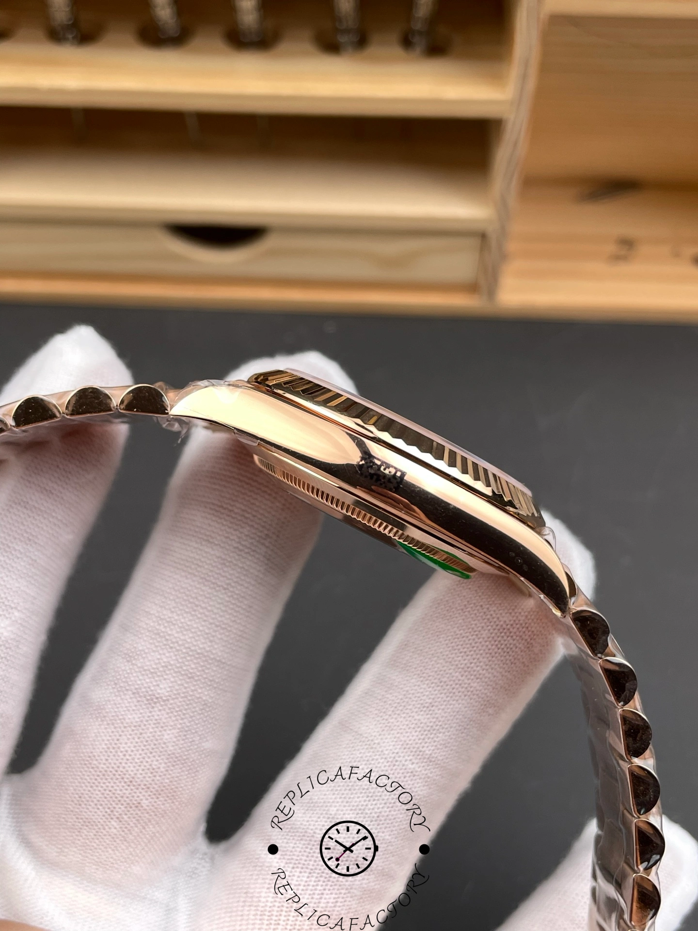 Side view of the Rolex Day-Date 40 Everose gold showing the smooth case profile and polished finish.