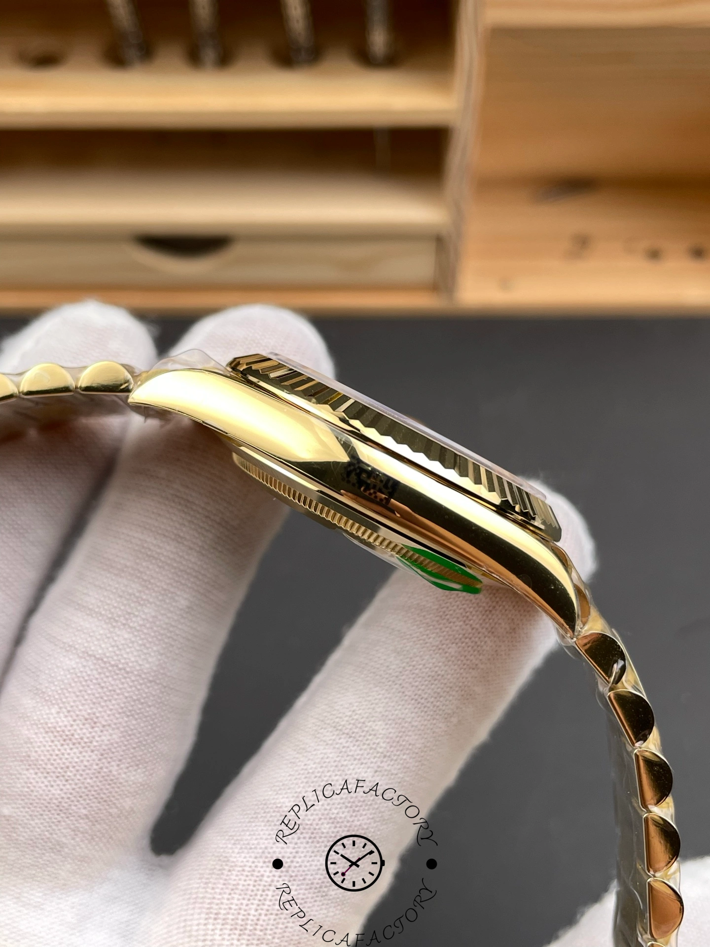 Alternate side angle showing the smooth polished gold case and bezel of the Rolex Day-Date 228238.