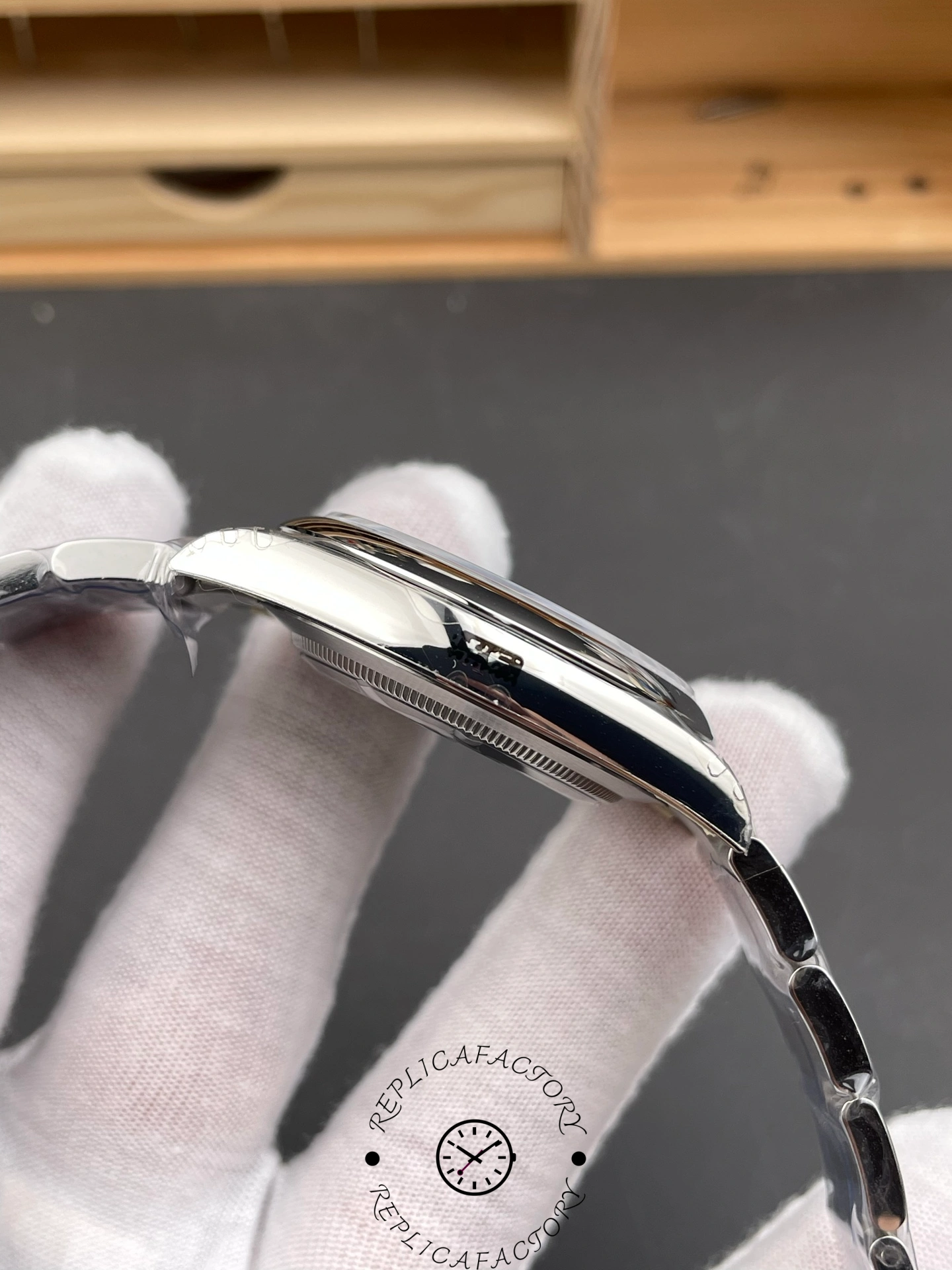 Side view of the Rolex Oyster Perpetual 41 showing the crown and polished stainless steel case profile.