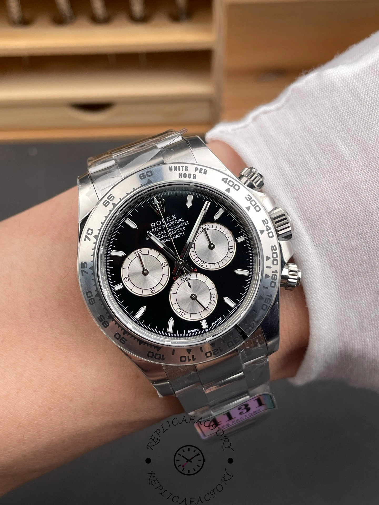 Wrist shot of the Rolex Cosmograph Daytona 126509-0001 showing the black dial and chronograph sub-dials in detail.