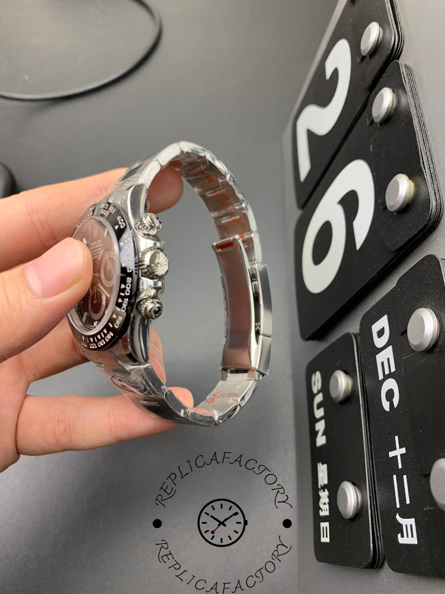 Side view of Rolex Cosmograph Daytona m126500ln-0002 showing chronograph pushers and brushed steel bracelet links.