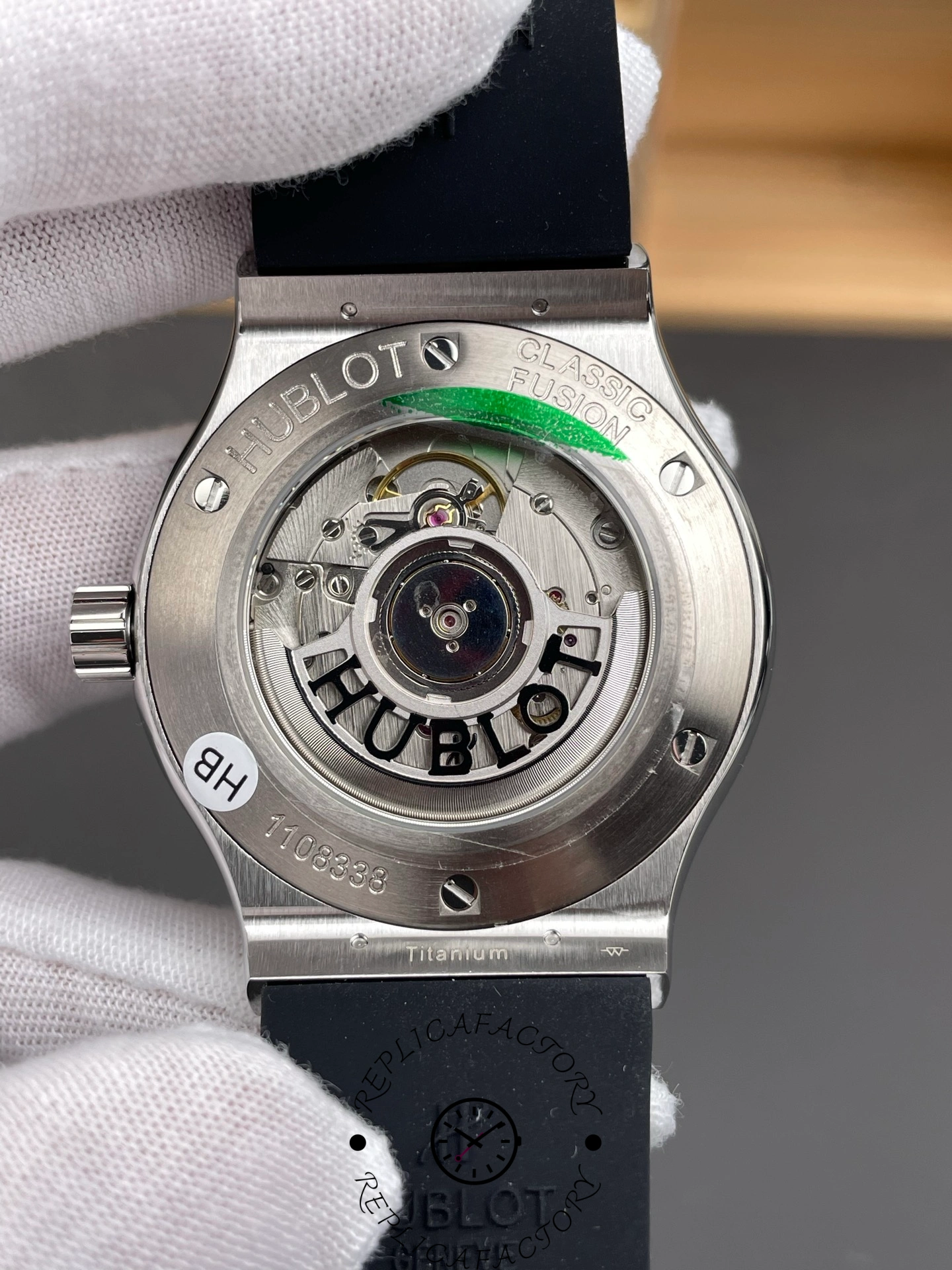 Transparent caseback showing automatic movement and engraved Hublot rotor on 542.NX.1171.RX replica.