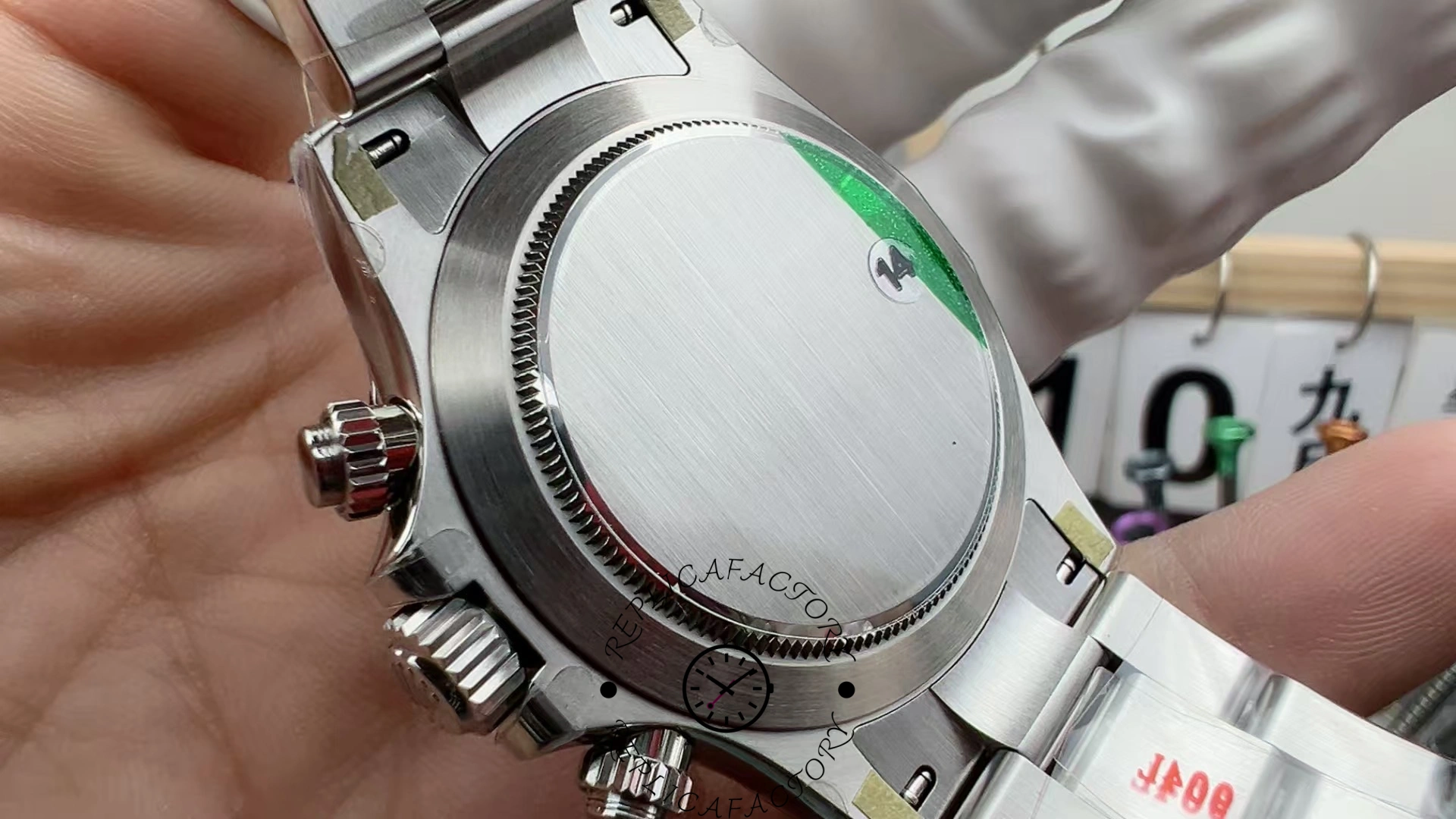 Caseback view of the Rolex Cosmograph Daytona M126500LN-0001 showing brushed steel finish and green protective seal.