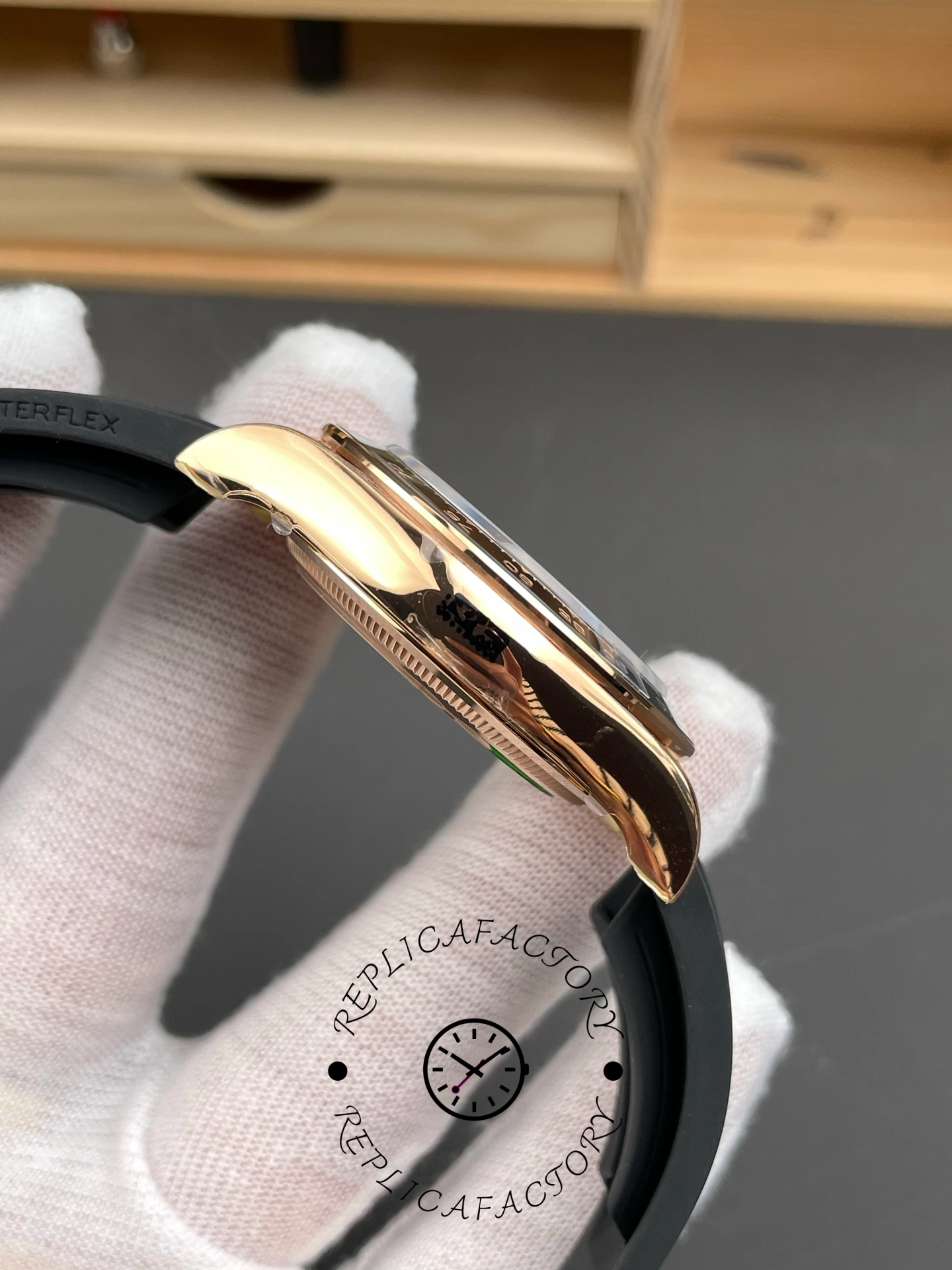 Left side view of ReplicaFactory Rolex Daytona 126515LN-0004 showing curved lugs and black Oysterflex strap.