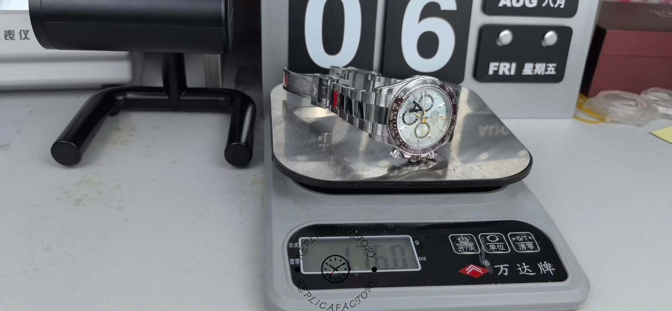 VS Factory Rolex Daytona 126506 placed on digital scale showing total weight in testing setup.