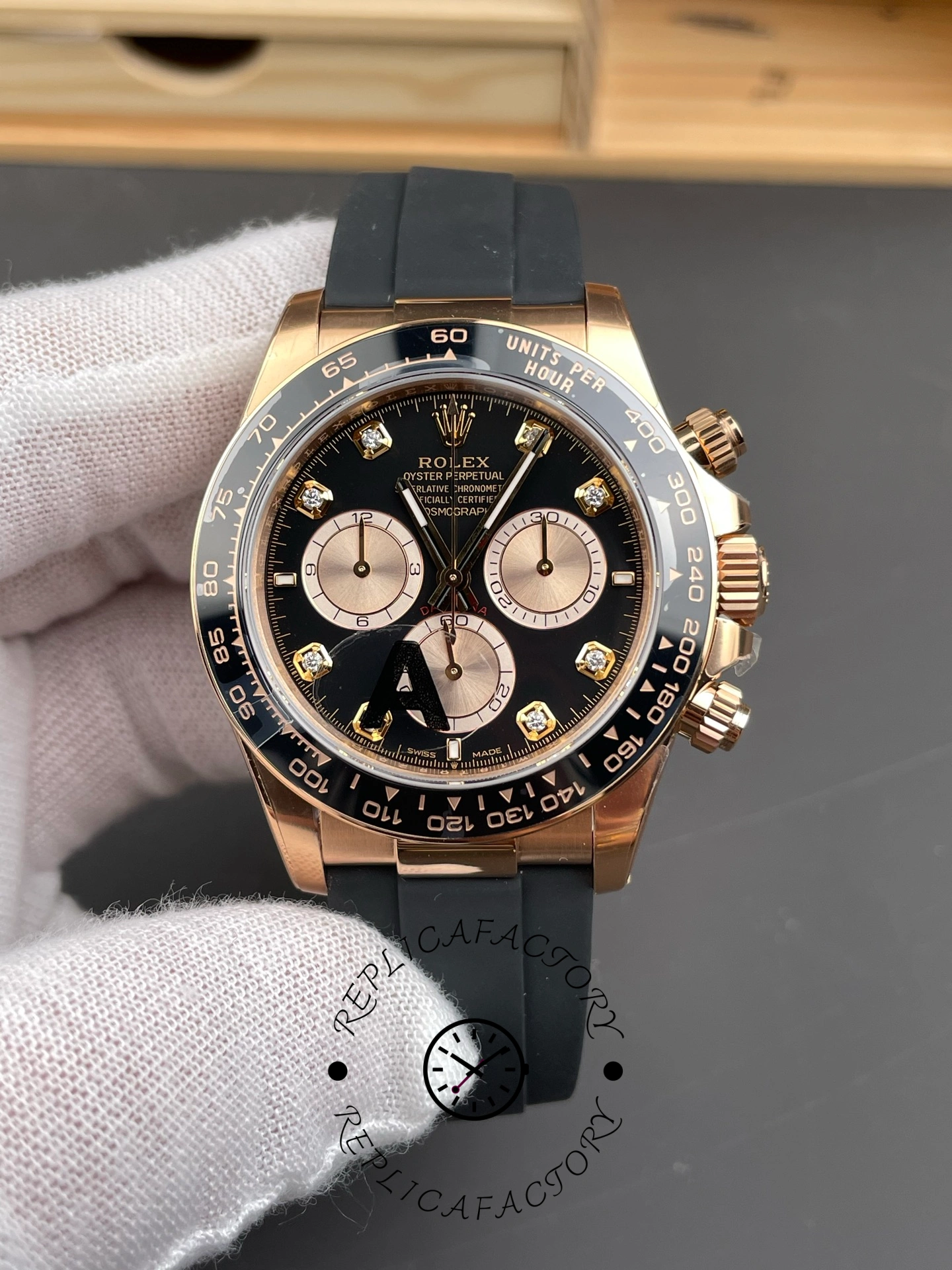 Front close-up of ReplicaFactory Rolex Daytona 126515LN-0004 showing Everose gold case and black dial.