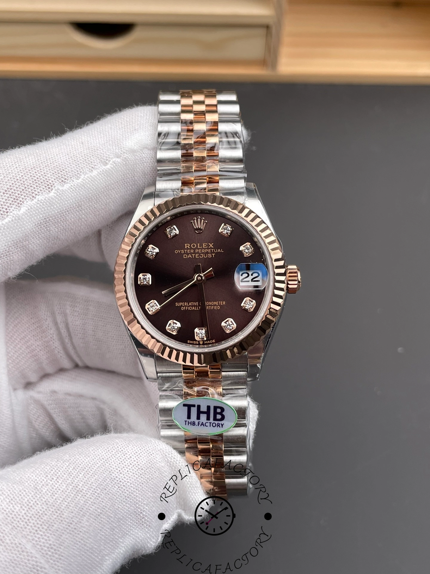 Front view of THB Factory Rolex Datejust 31 ref. 278271-0028 showing chocolate sunburst dial and rose gold fluted bezel.