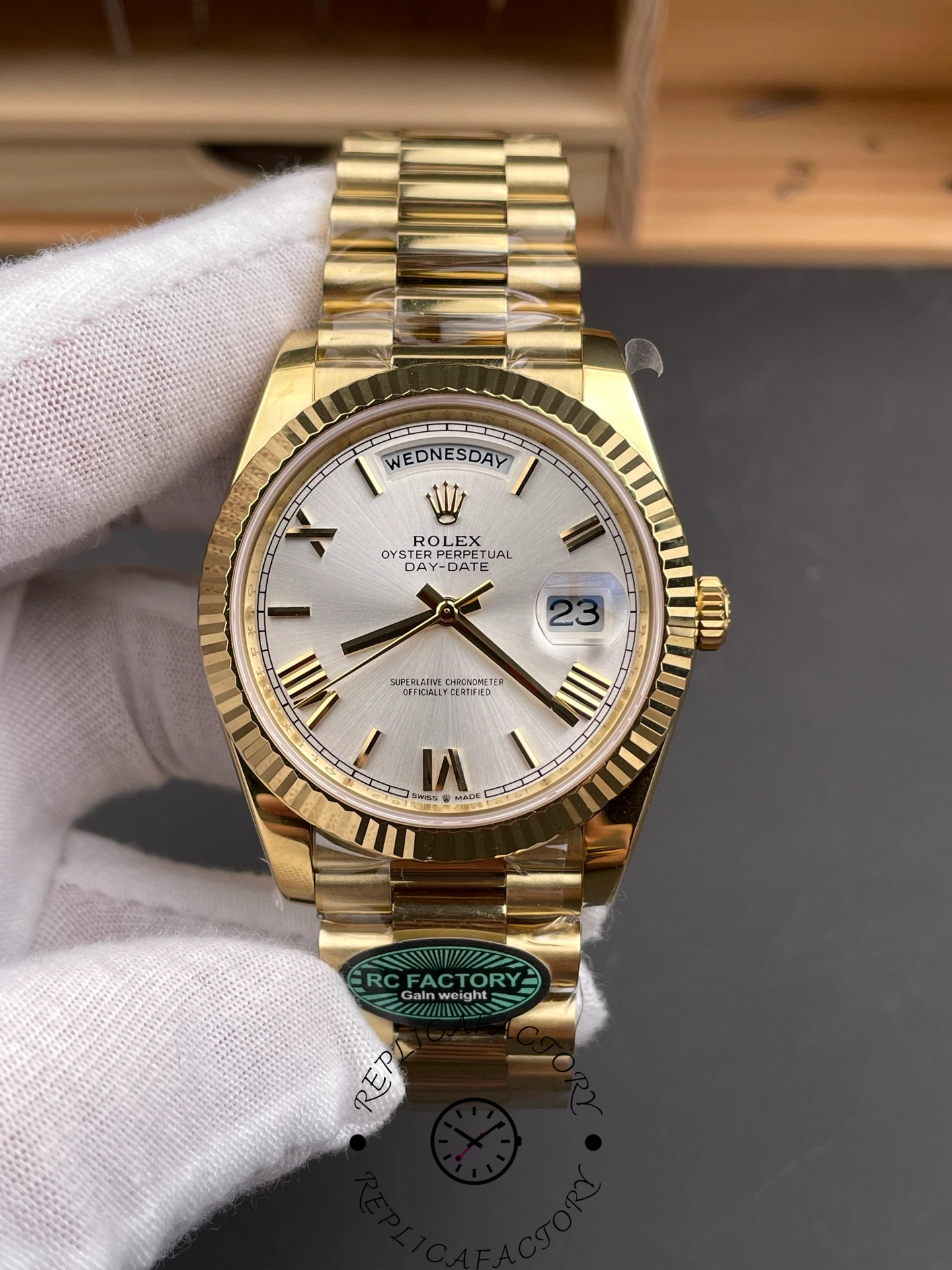 Front view of RC Factory Rolex Day-Date 228238 showing silver Roman dial and yellow gold case.