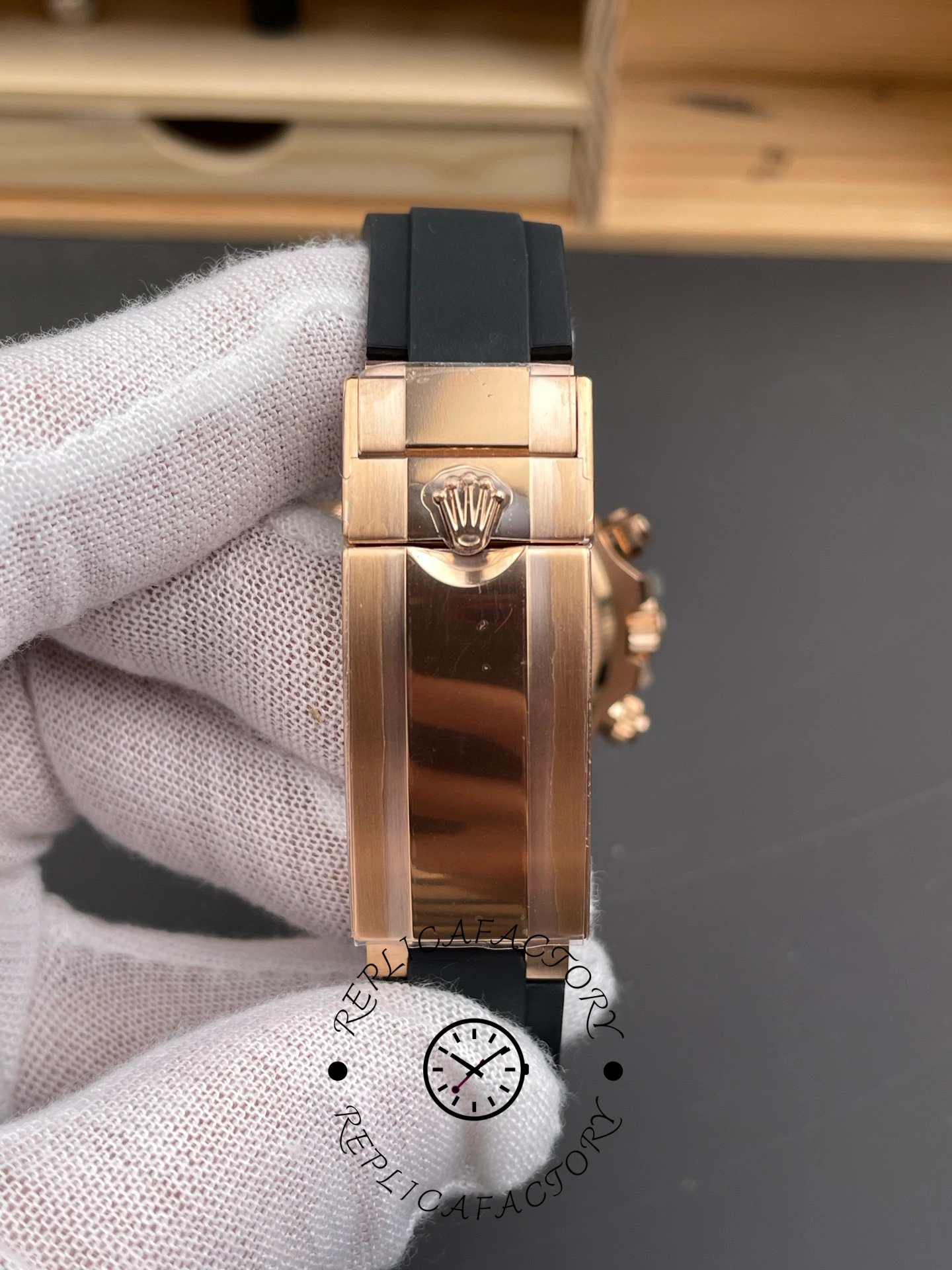 Bracelet clasp exterior of ReplicaFactory Rolex Daytona 126515LN-0004 showing polished Everose clasp with Rolex crown.