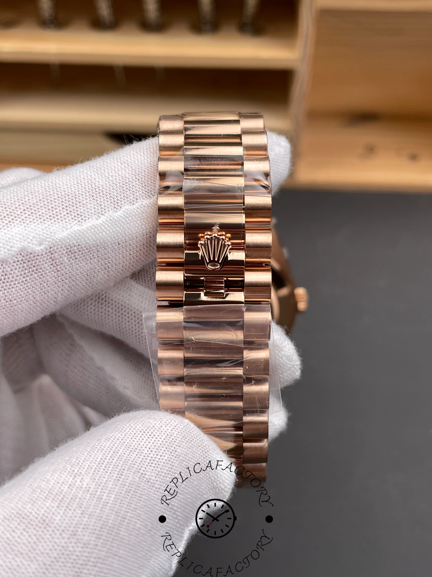 Close-up of Rolex Day-Date 228235 clasp showing Rolex crown logo on Everose gold bracelet.