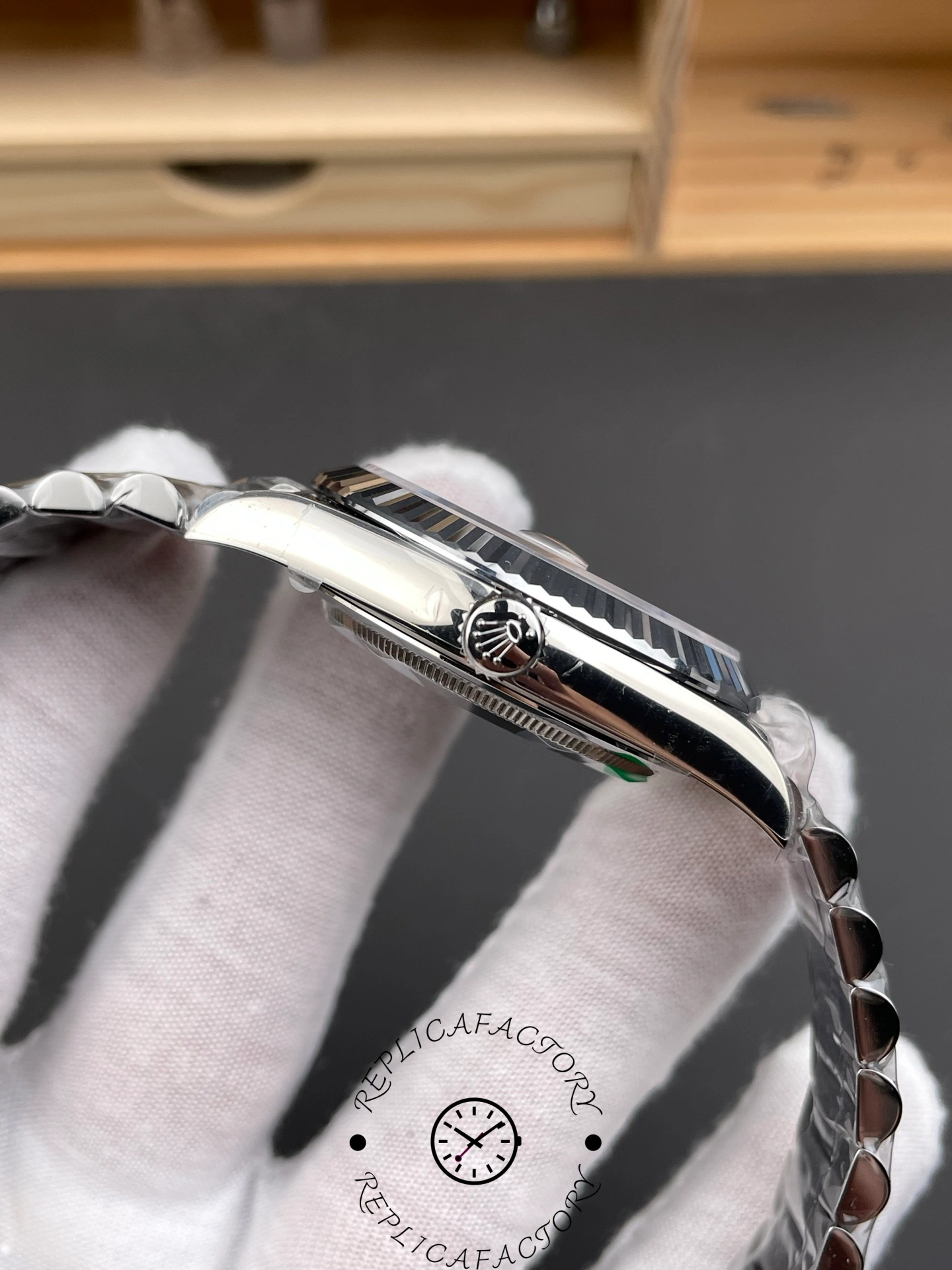 Side view of RC Factory Rolex Day-Date 228239 showing white gold crown and polished case.