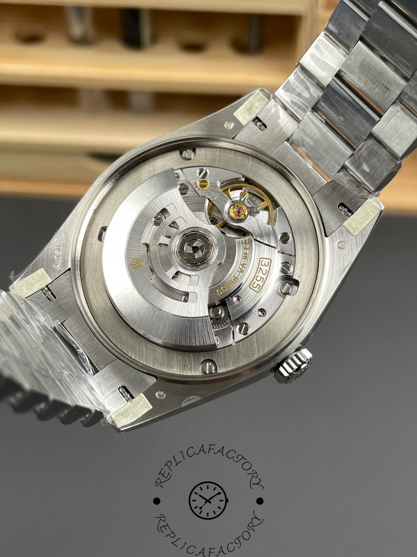 Caseback open view of RC Factory Rolex Day-Date 228239 showing visible automatic movement.