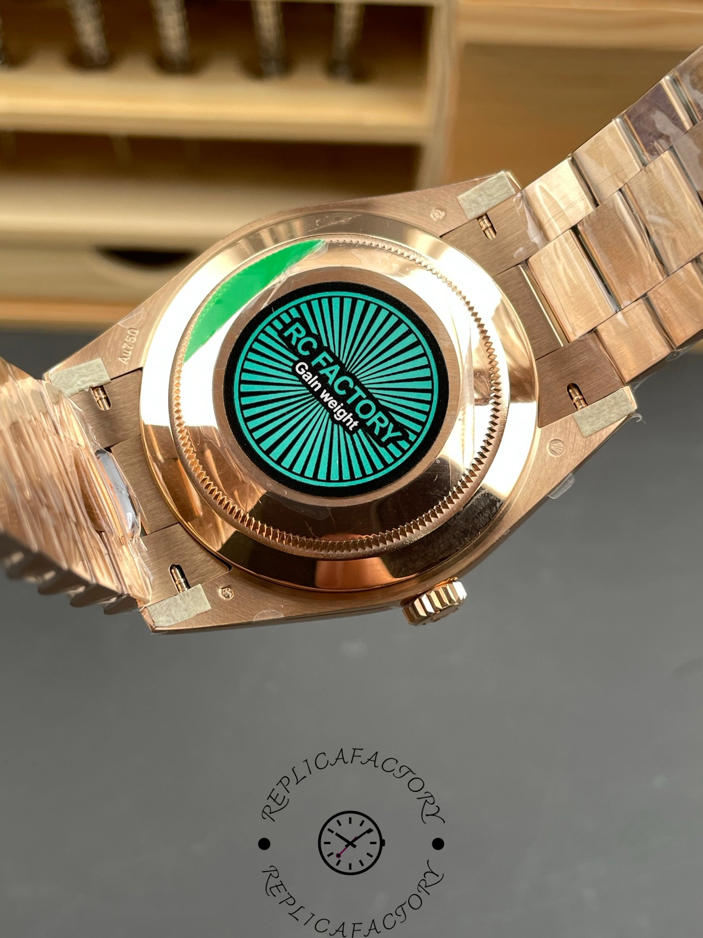 Case back view of RC Factory Rolex Day-Date 228235 with green factory sticker.