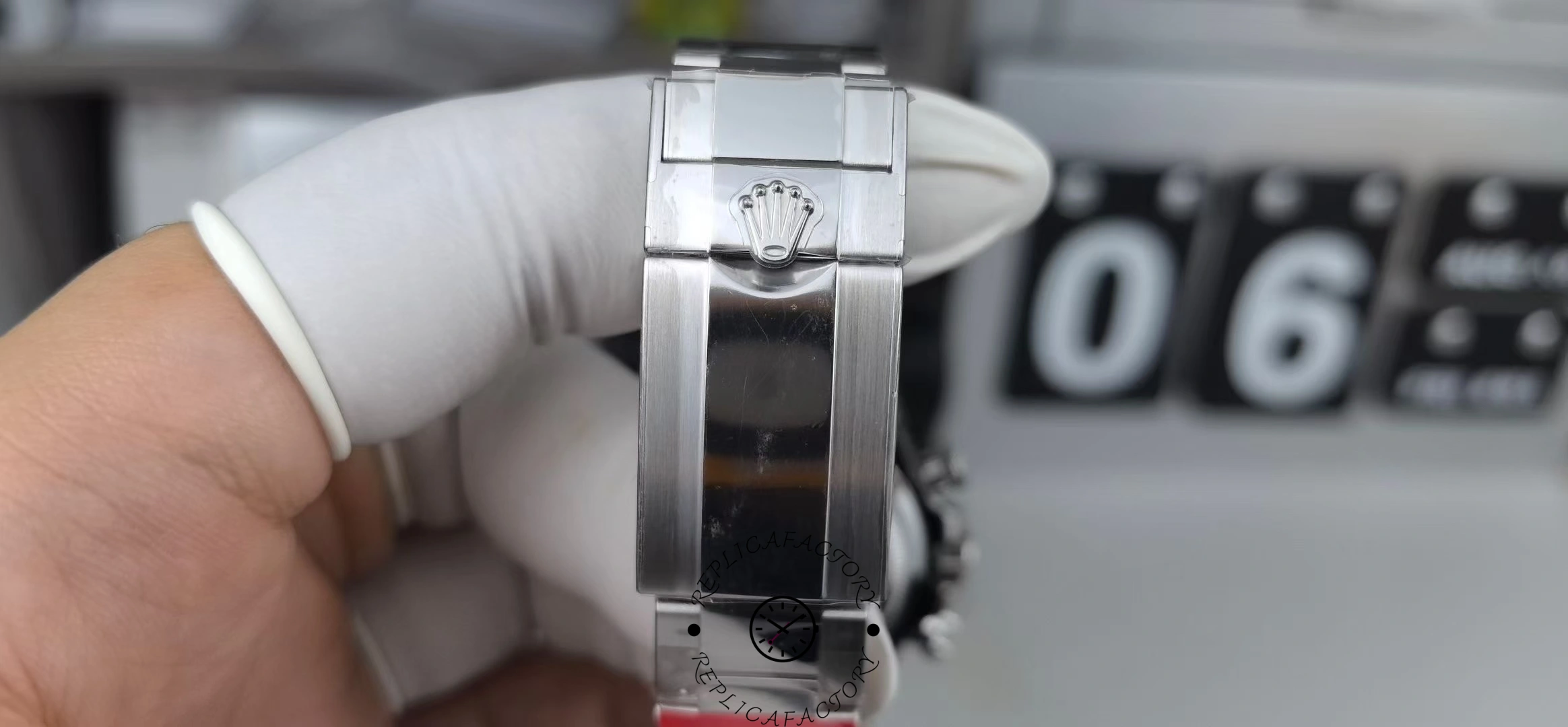 Clasp close-up of VS Factory Rolex Daytona 126506 with Rolex crown on polished surface.