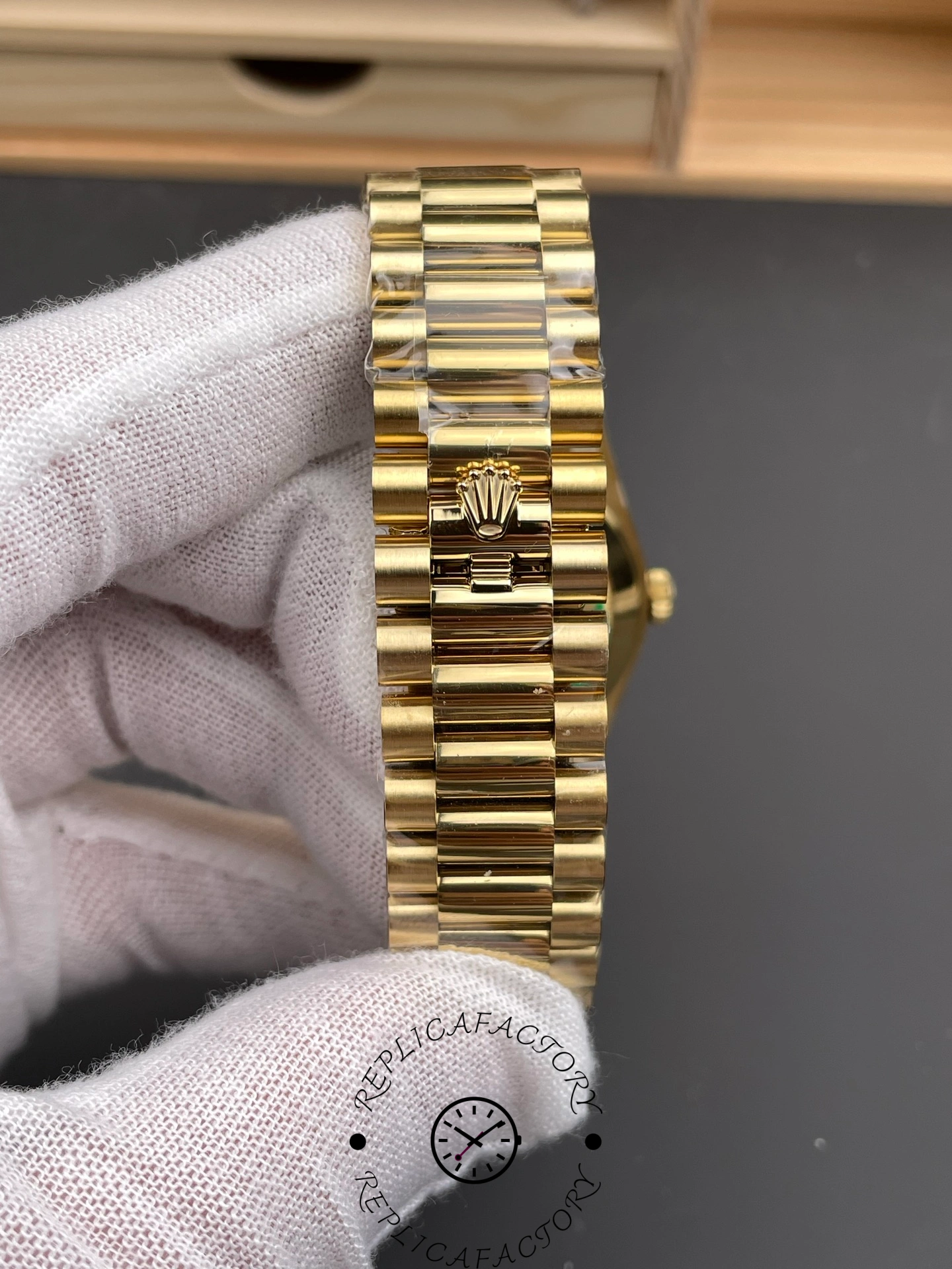 Close-up of the Rolex Day-Date 228238 clasp showing the Rolex crown logo on bracelet.