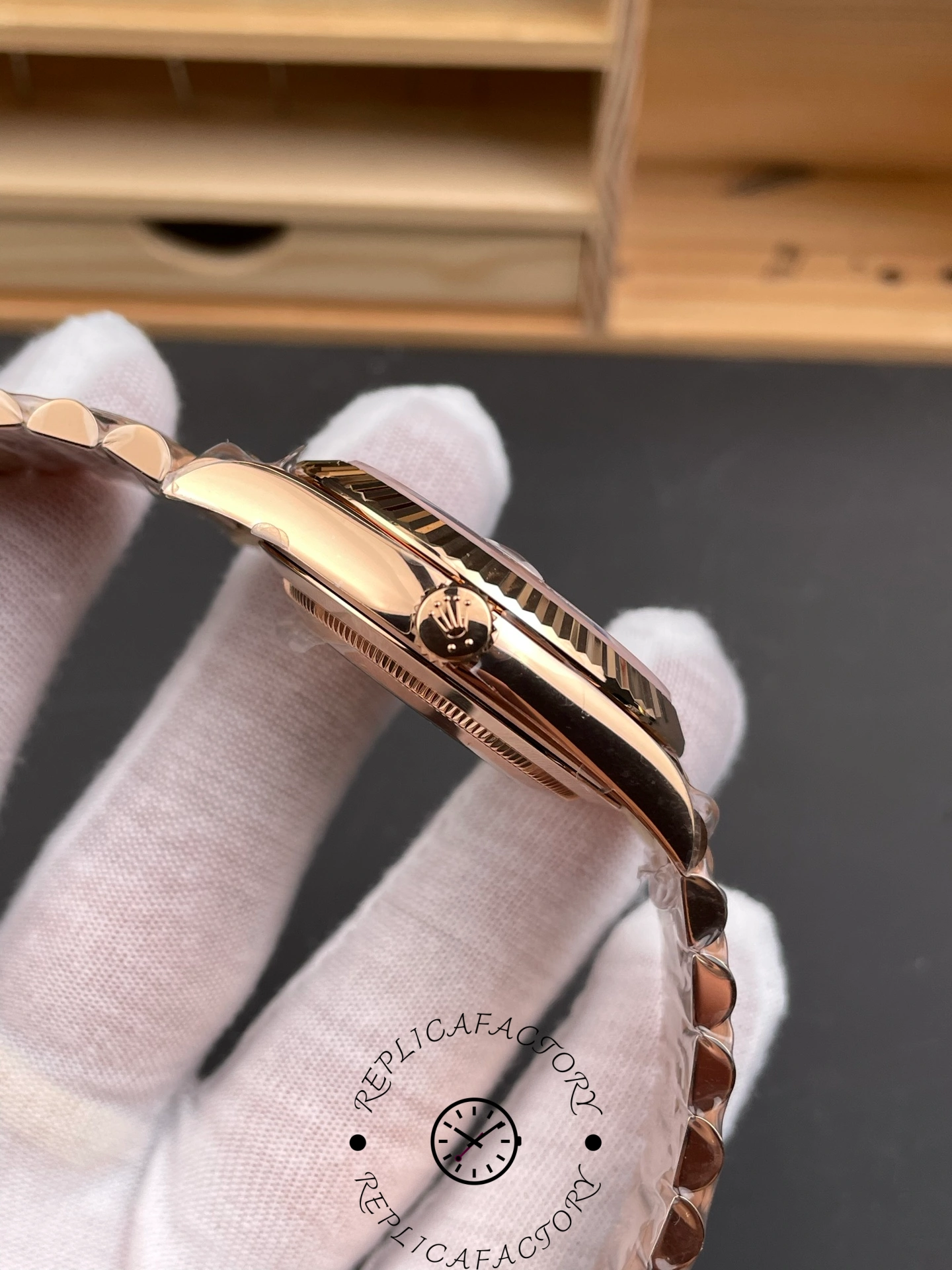 Side view of RC Factory Rolex Day-Date 228235 showing Everose gold crown and polished case.