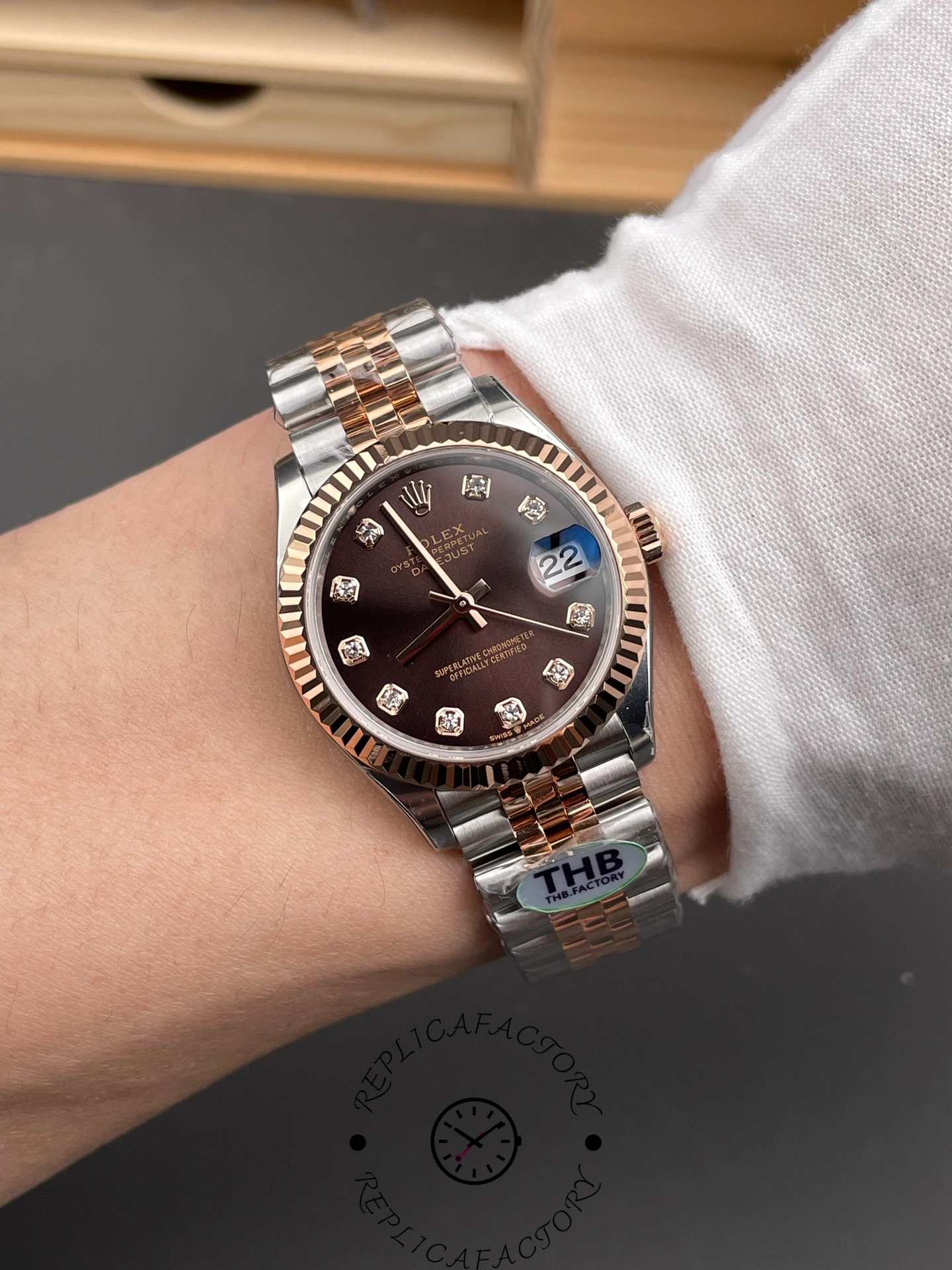 Wrist shot of THB Factory Rolex Datejust 31 ref. 278271-0028 showing chocolate dial with diamond hour markers under natural light.