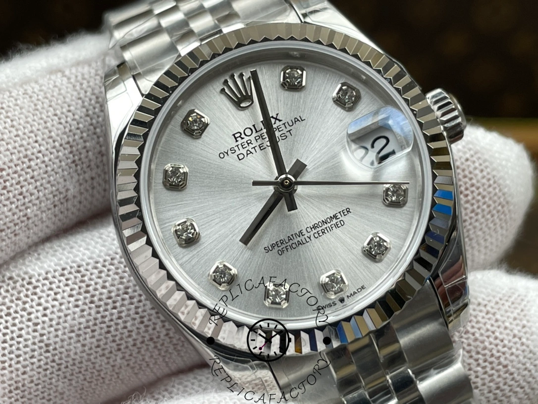 Macro shot of ReplicaFactory Rolex Datejust m278274-0030 focusing on diamond-set hour markers and silver sunburst texture.