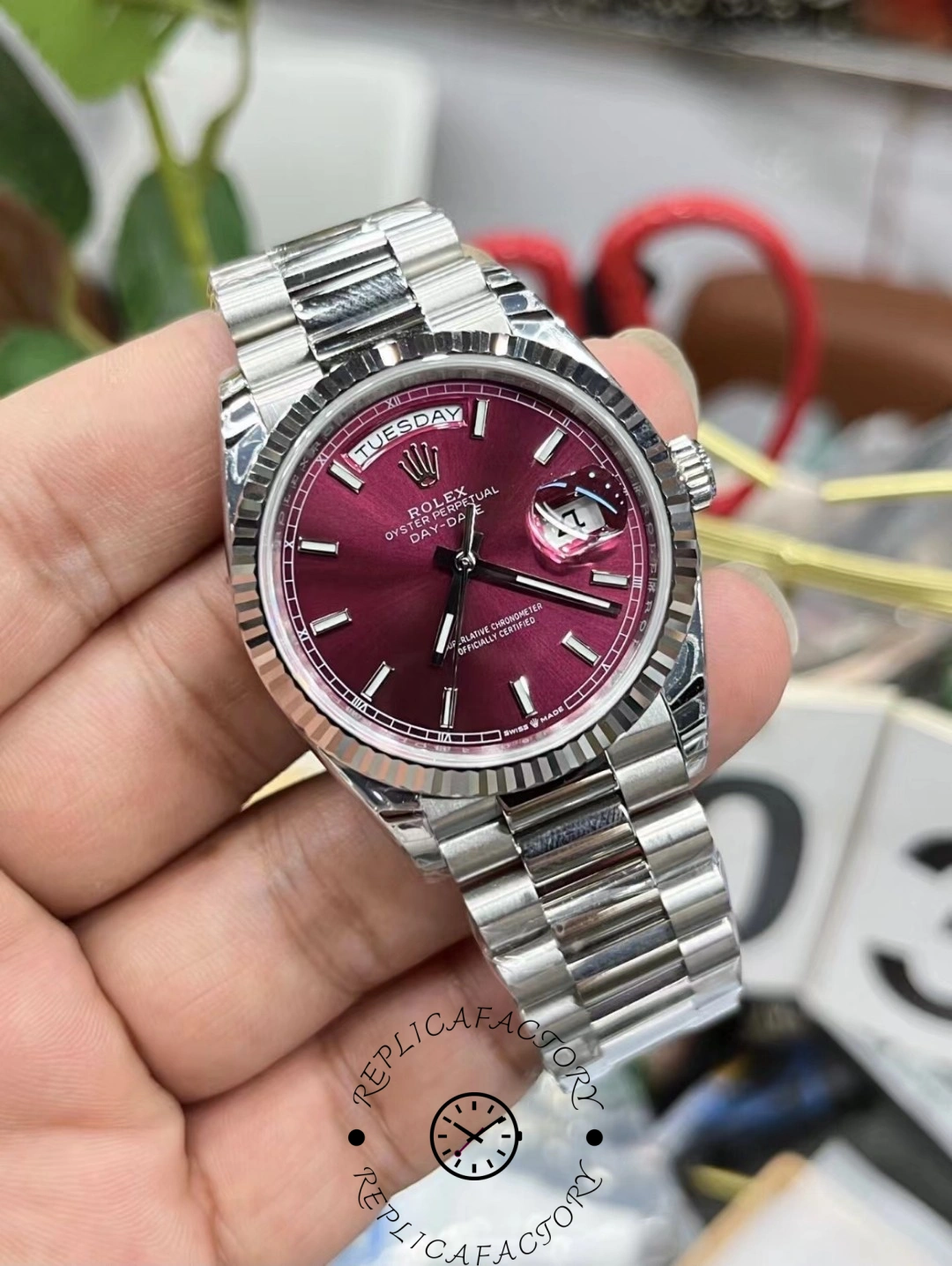 Rolex Day-Date 36mm cherry red dial close-up showing fluted bezel details