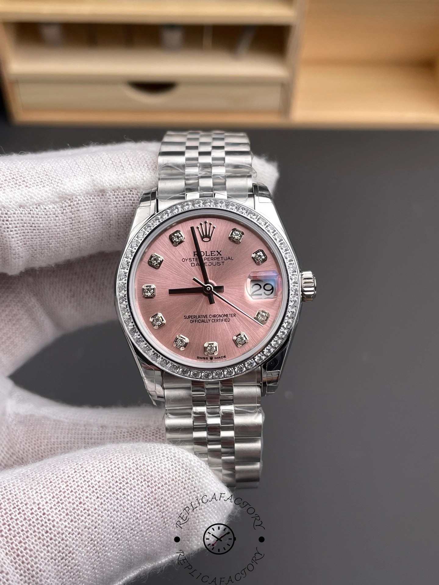 Real photo of Rolex Datejust 31 m278384rbr 0036 showing pink sunburst dial and diamond hour markers.
