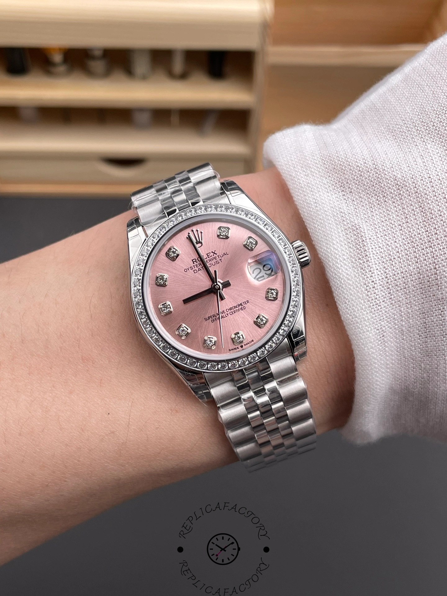 Wrist shot of Rolex Datejust 31 m278384rbr 0036 pink dial with diamond bezel on jubilee bracelet.
