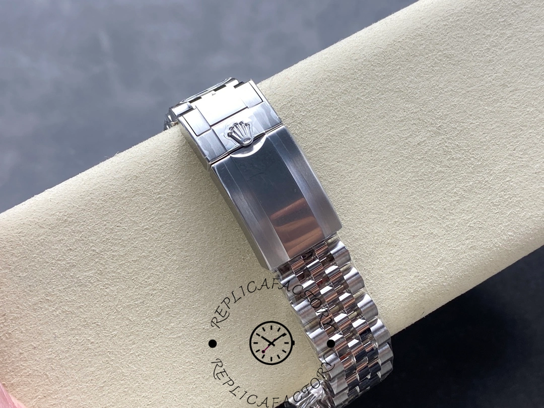 Bracelet clasp of Rolex GMT-Master II 126710BLRO showing Rolex crown engraving and polished surface.