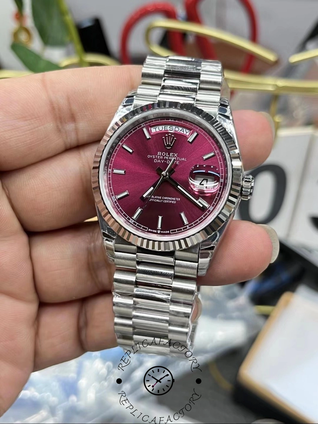 Rolex Day-Date 36mm cherry red dial close-up showing fluted bezel details