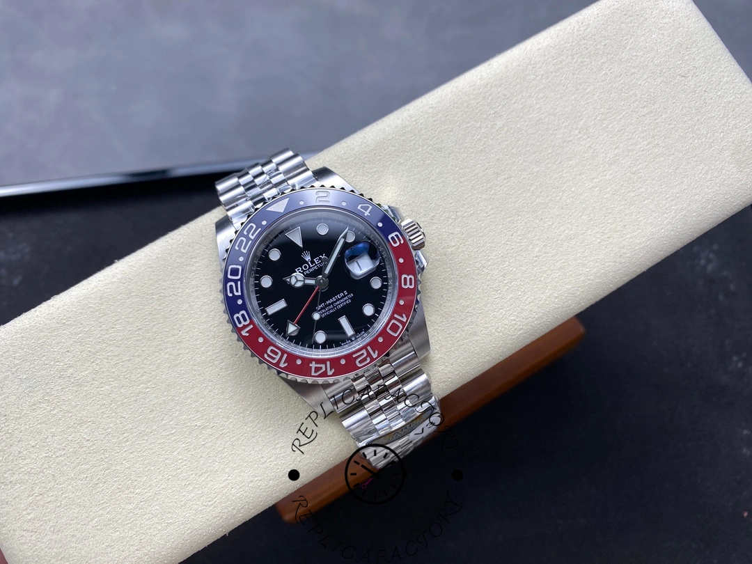 Rolex GMT-Master II 126710BLRO displayed diagonally on beige holder, full view of bracelet and dial.