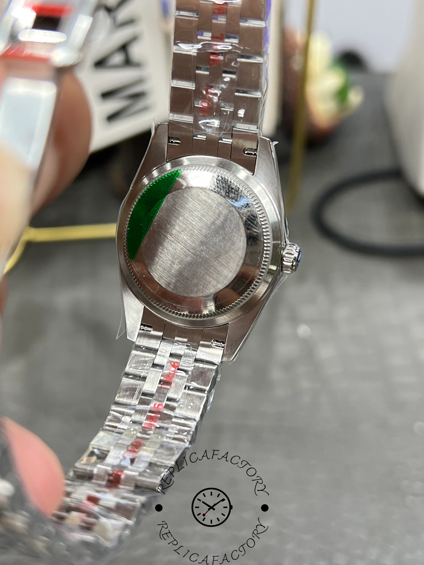 Caseback of ReplicaFactory Rolex Datejust 31mm 278274-0026 showing brushed steel back and green seal.