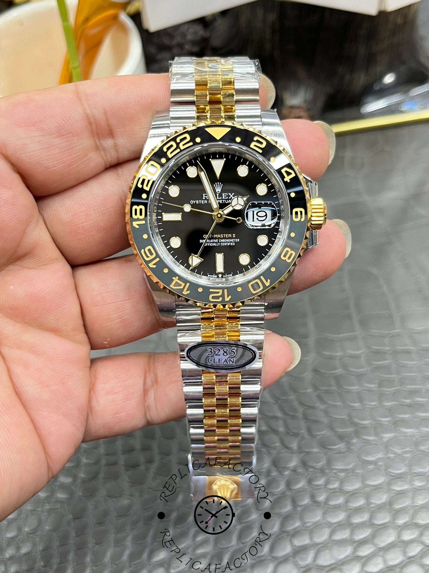 Real photo of Rolex GMT-Master II 126713GRNR-0001 showing two-tone bezel and 24-hour hand.