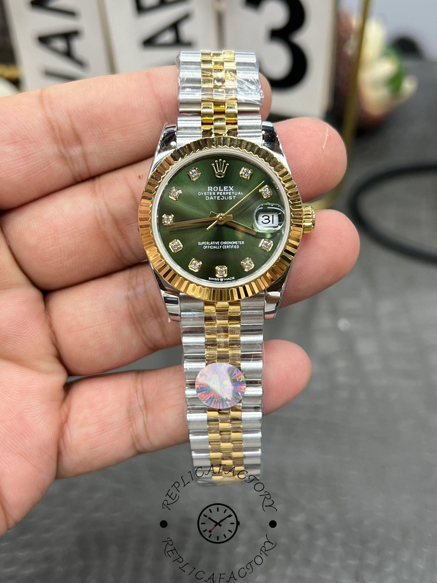 Front view of ReplicaFactory Rolex Datejust 31mm 278273-0030 showing green dial and fluted yellow gold bezel.