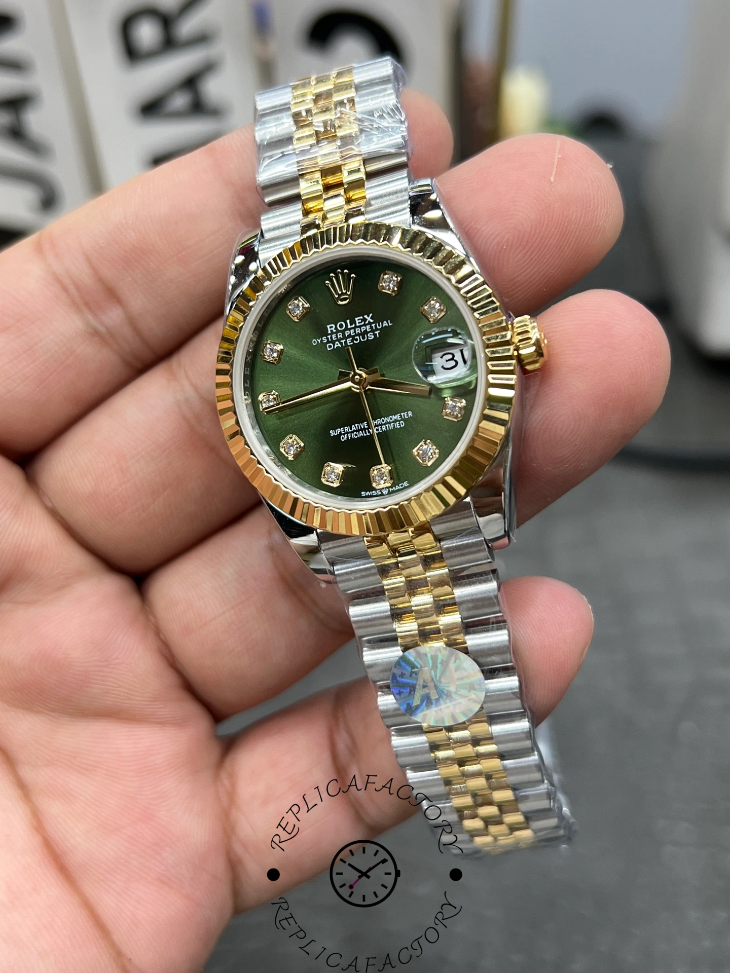 Angled close-up of ReplicaFactory Rolex Datejust 31mm 278273-0030 highlighting green dial with diamond hour markers.