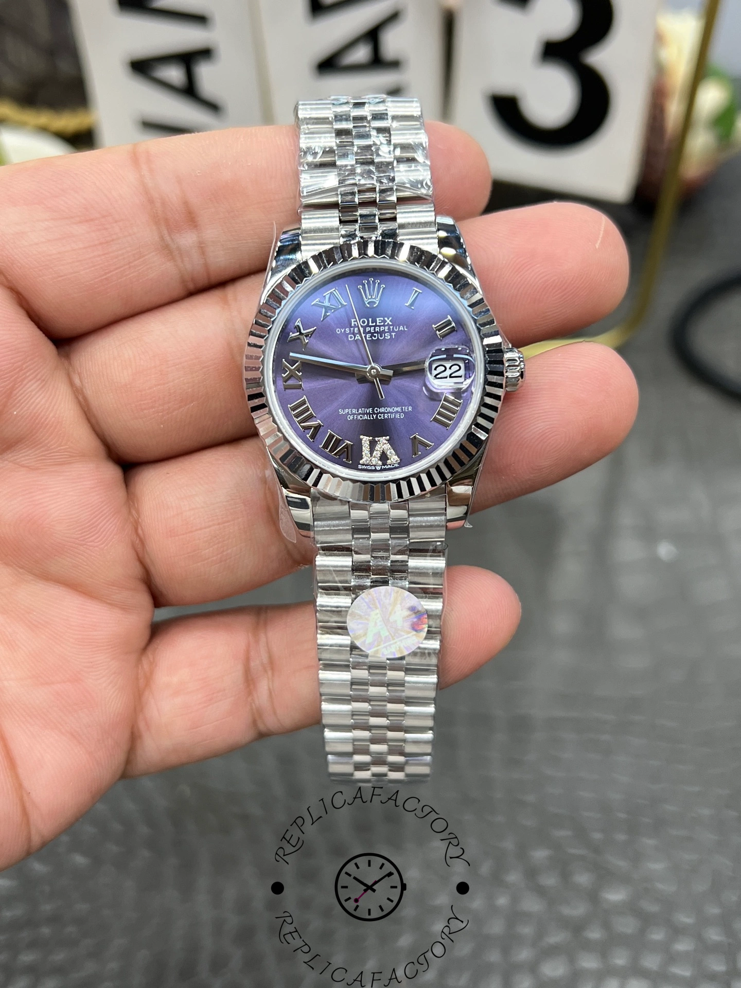 Front close-up of ReplicaFactory Rolex Datejust 31mm 278274-0026 showing purple dial and fluted white gold bezel.