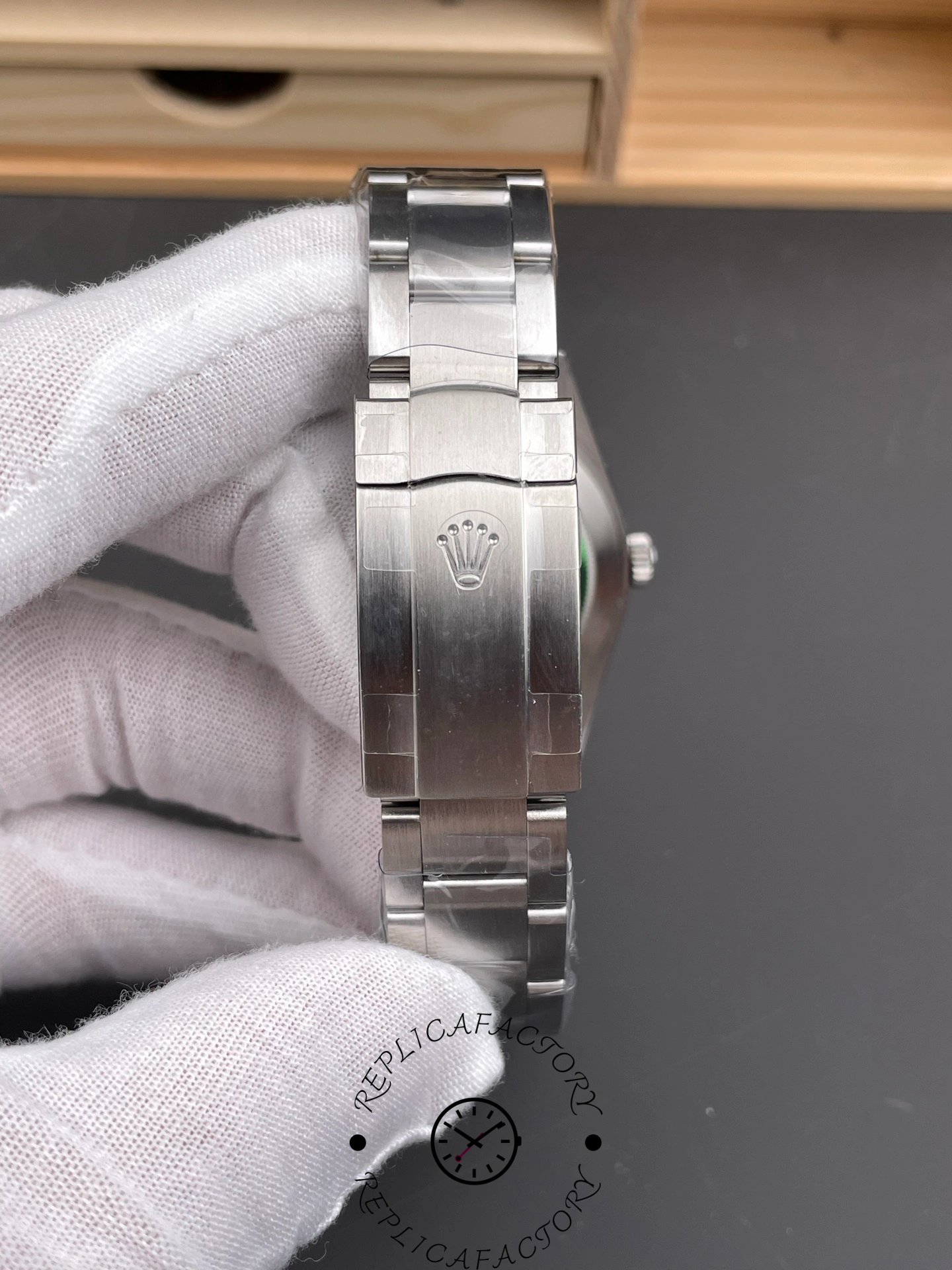 Bracelet clasp of Rolex Oyster Perpetual 114300 with Rolex crown emblem.