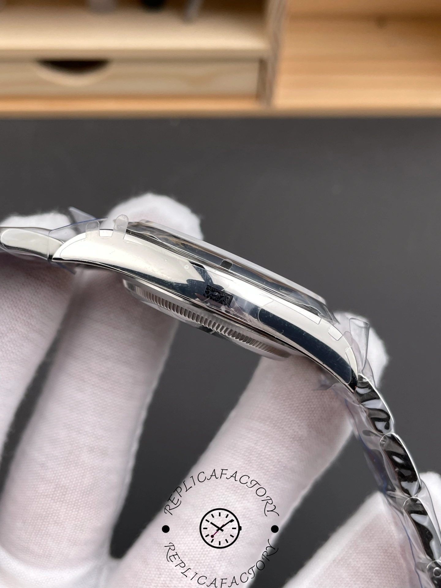 Side profile of Rolex Oyster Perpetual 114300 with polished case.