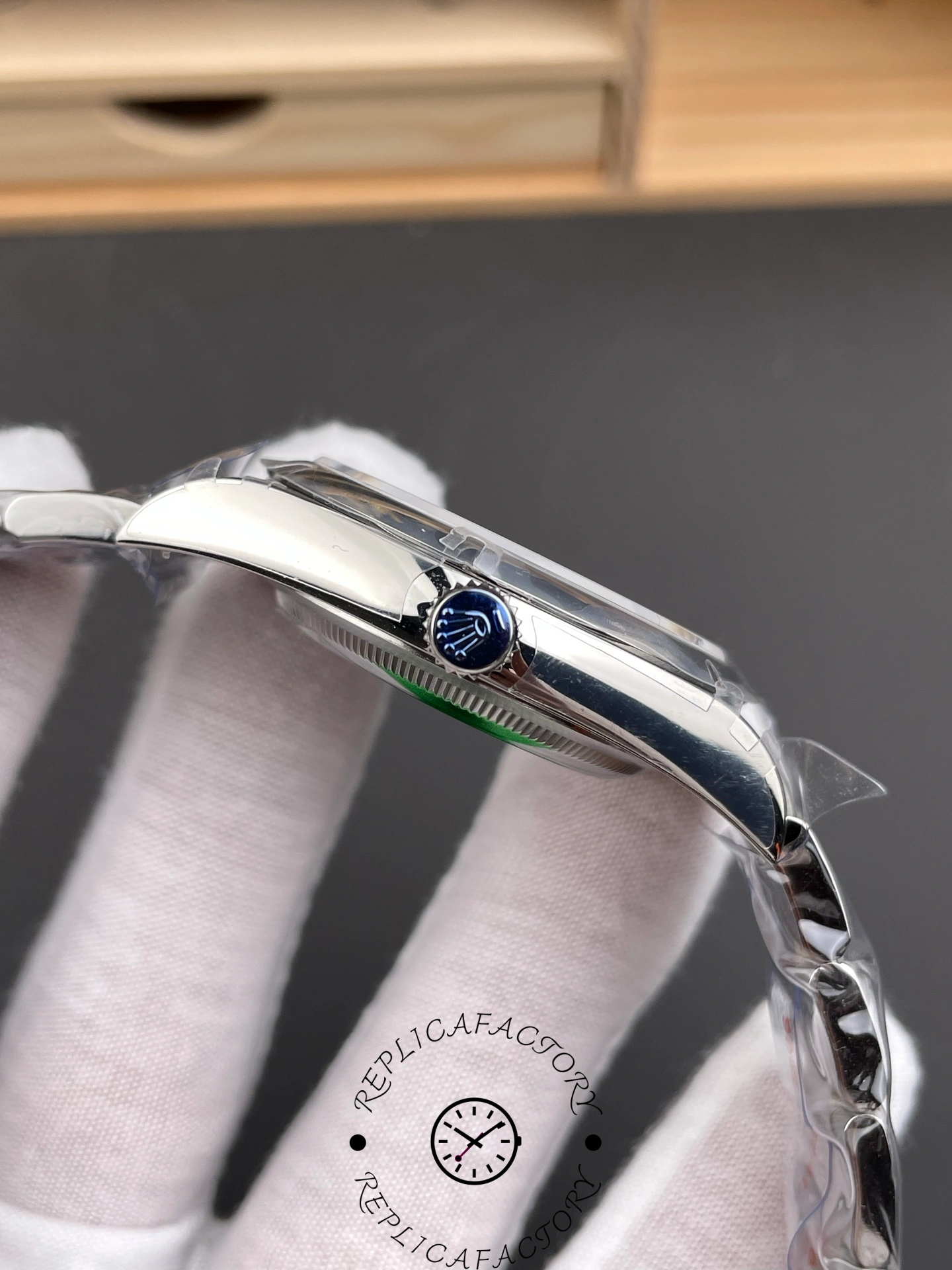 Side view of Rolex Oyster Perpetual 114300 showing crown with Rolex logo.