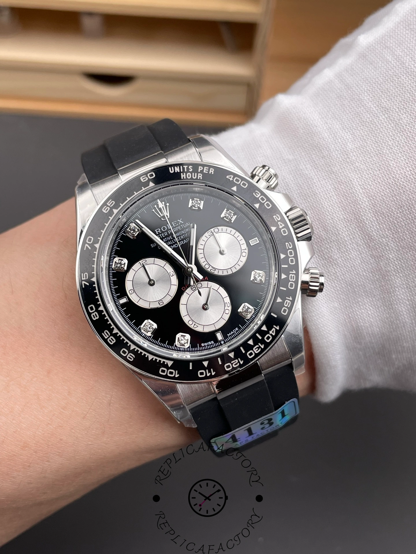 Wrist shot of Rolex Daytona 126519LN showing black dial, diamond hour markers, and black rubber strap.