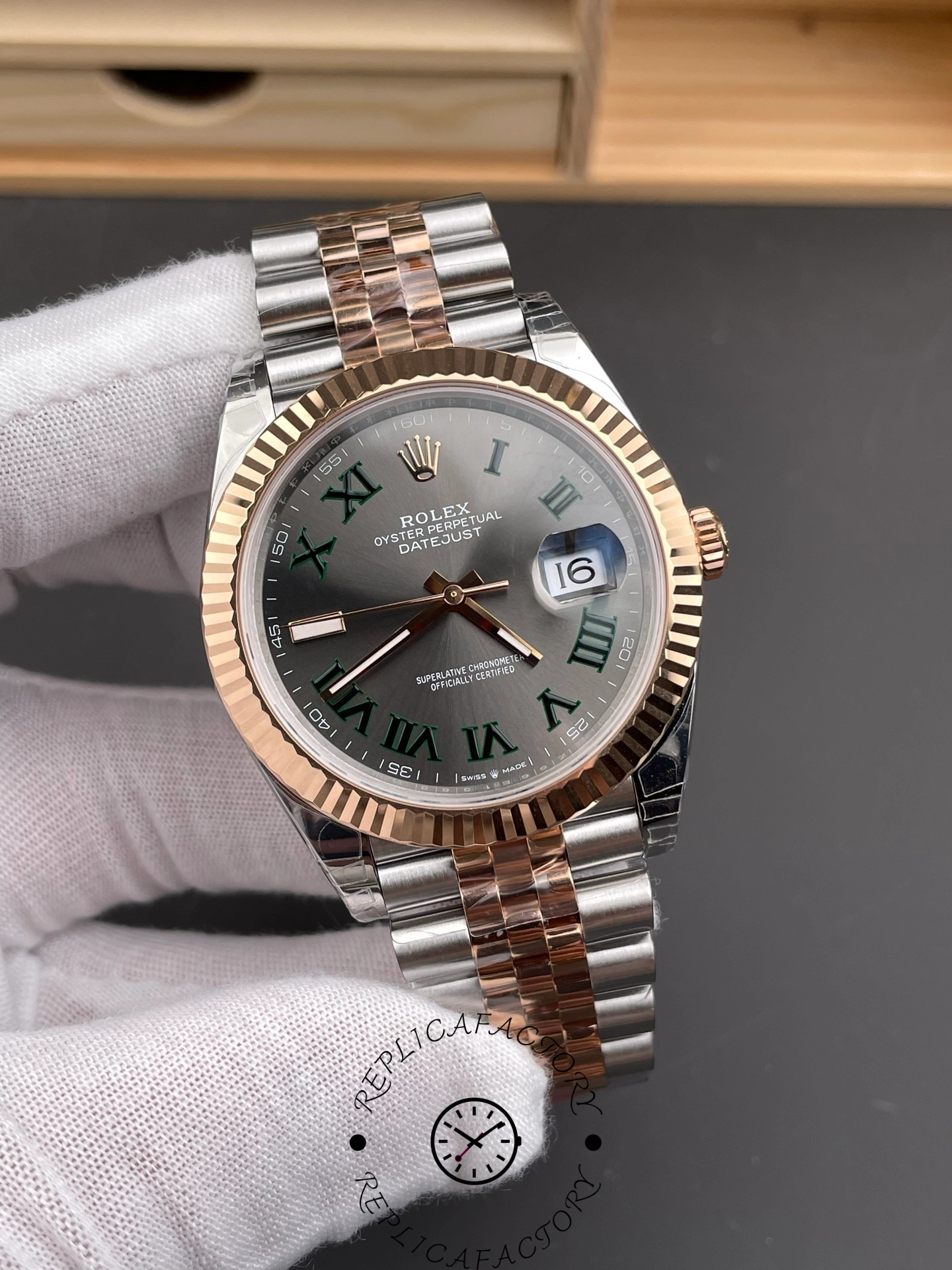 Angled front of Rolex Datejust 41 m126331-0016 showing Everose fluted bezel and jubilee bracelet.