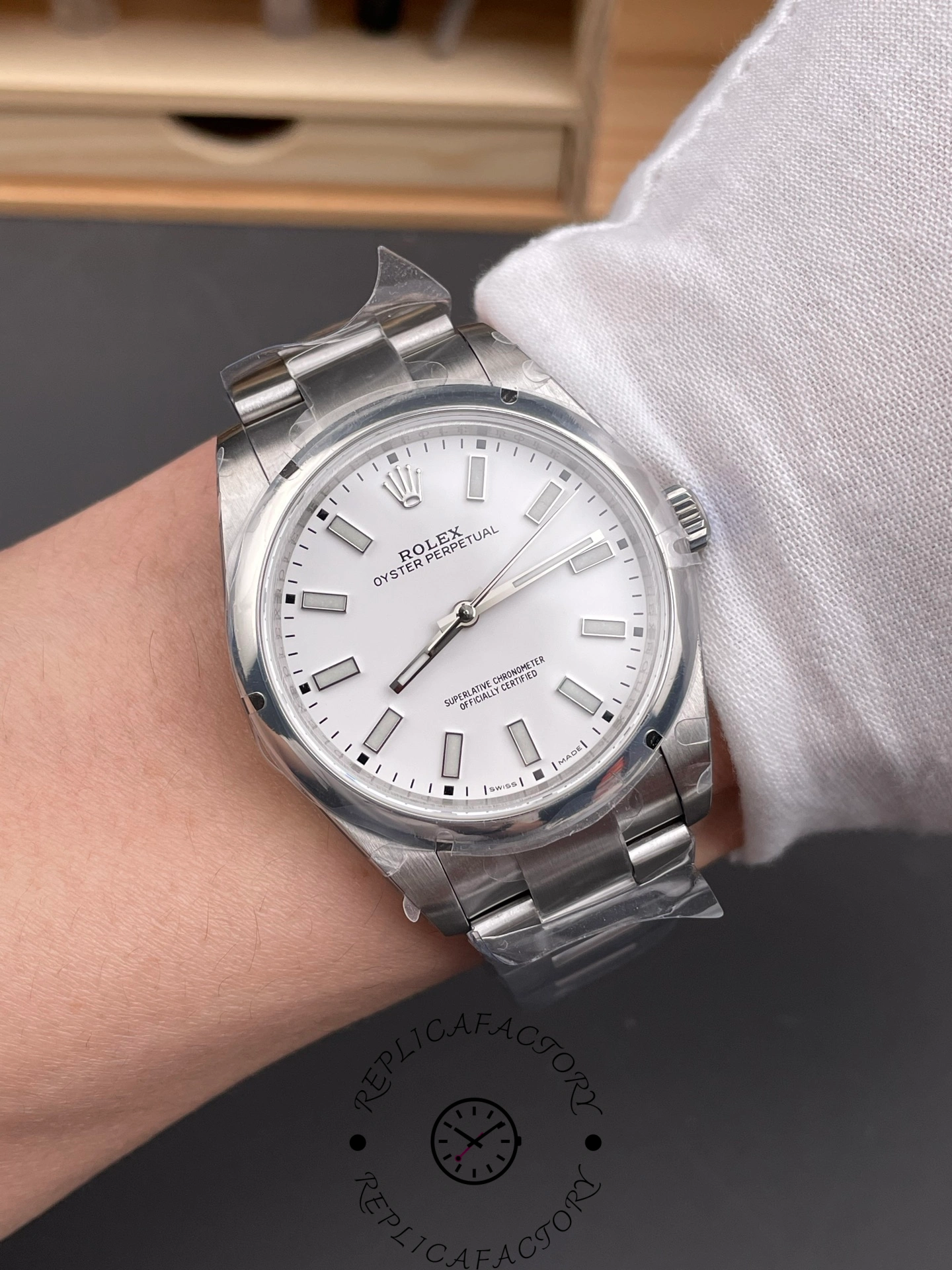 Wrist shot of Rolex Oyster Perpetual 114300 white dial with smooth bezel.