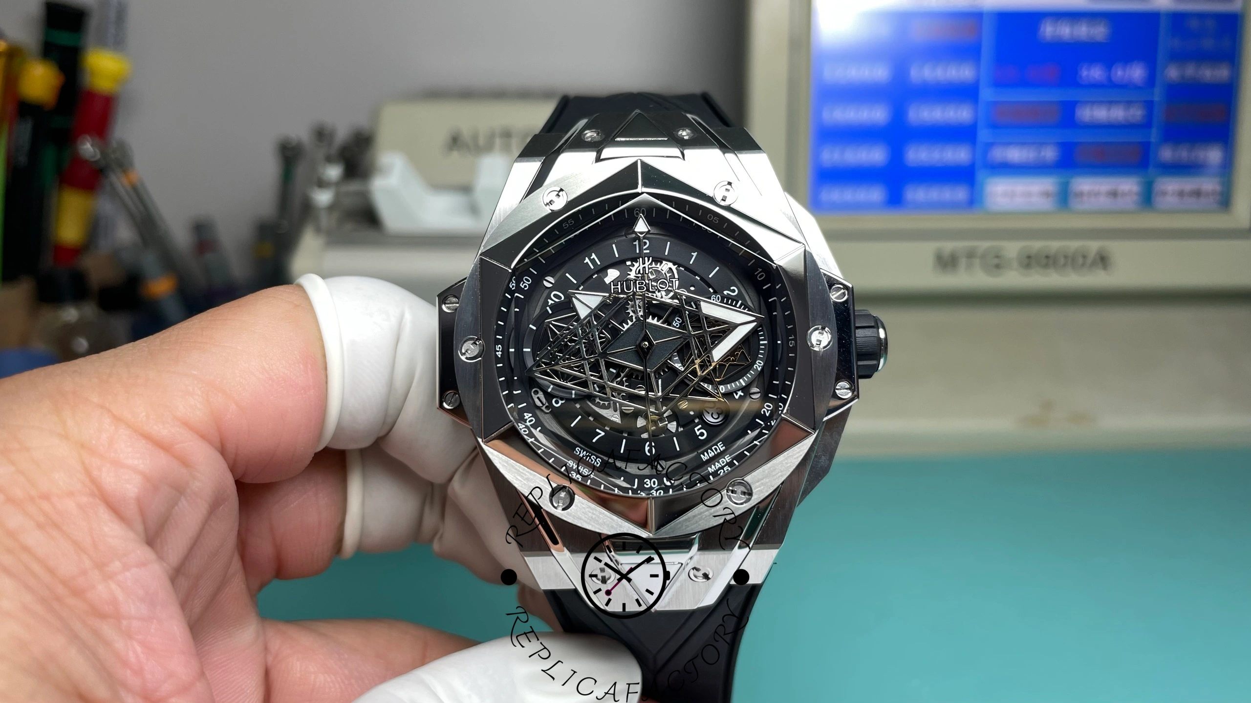 Front view of Hublot Big Bang Sang Bleu II Titanium 45mm held by gloved hand.