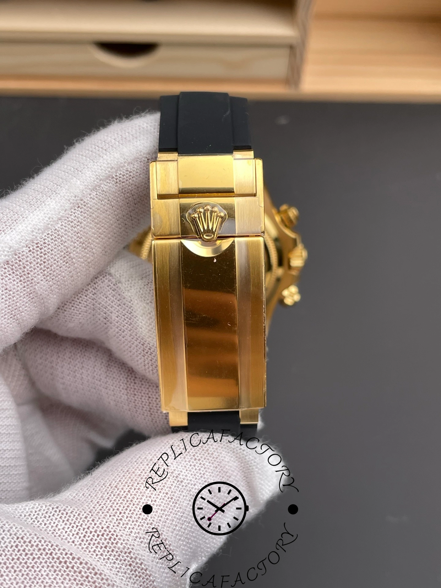 Close-up of Rolex Daytona 126518LN clasp with engraved crown logo on gold folding buckle.