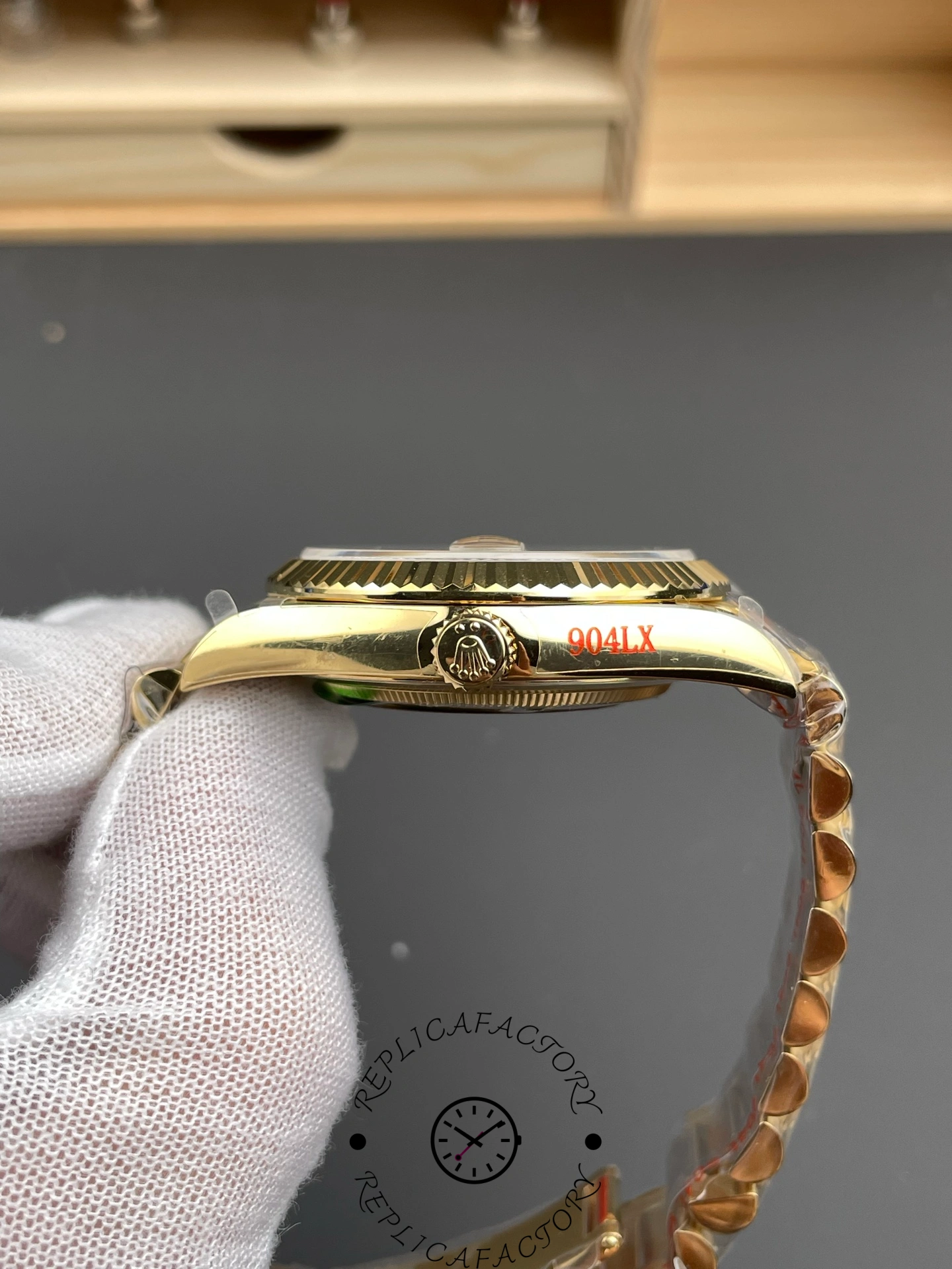 Side view of Rolex Day-Date 40 m228238-0005 showing fluted bezel and gold crown logo.