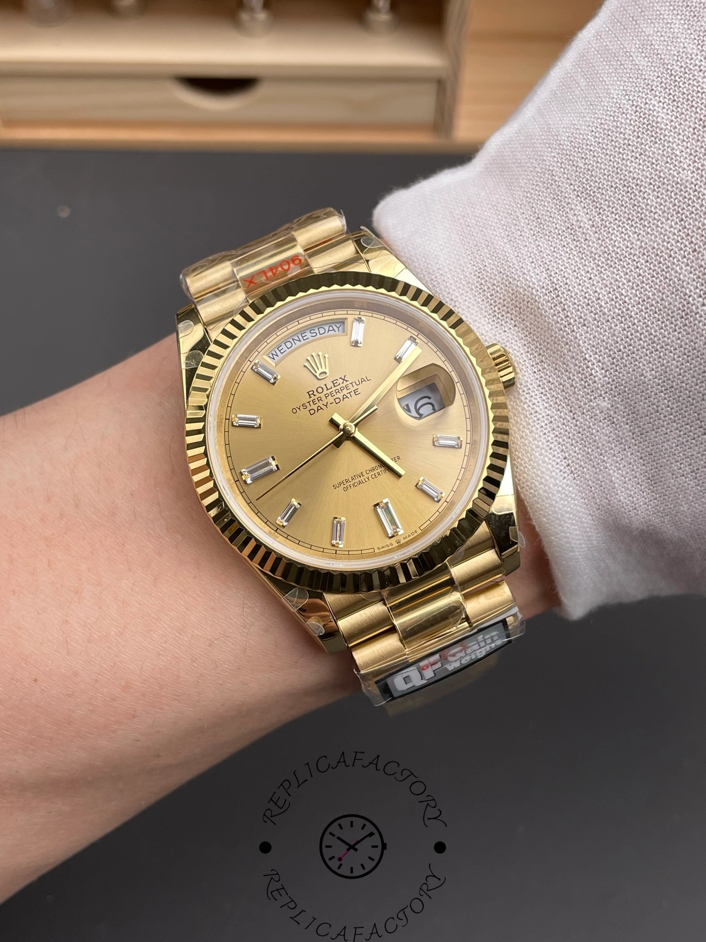 Wrist shot of Rolex Day-Date 40 m228238-0005 on hand showing elegant gold finish.